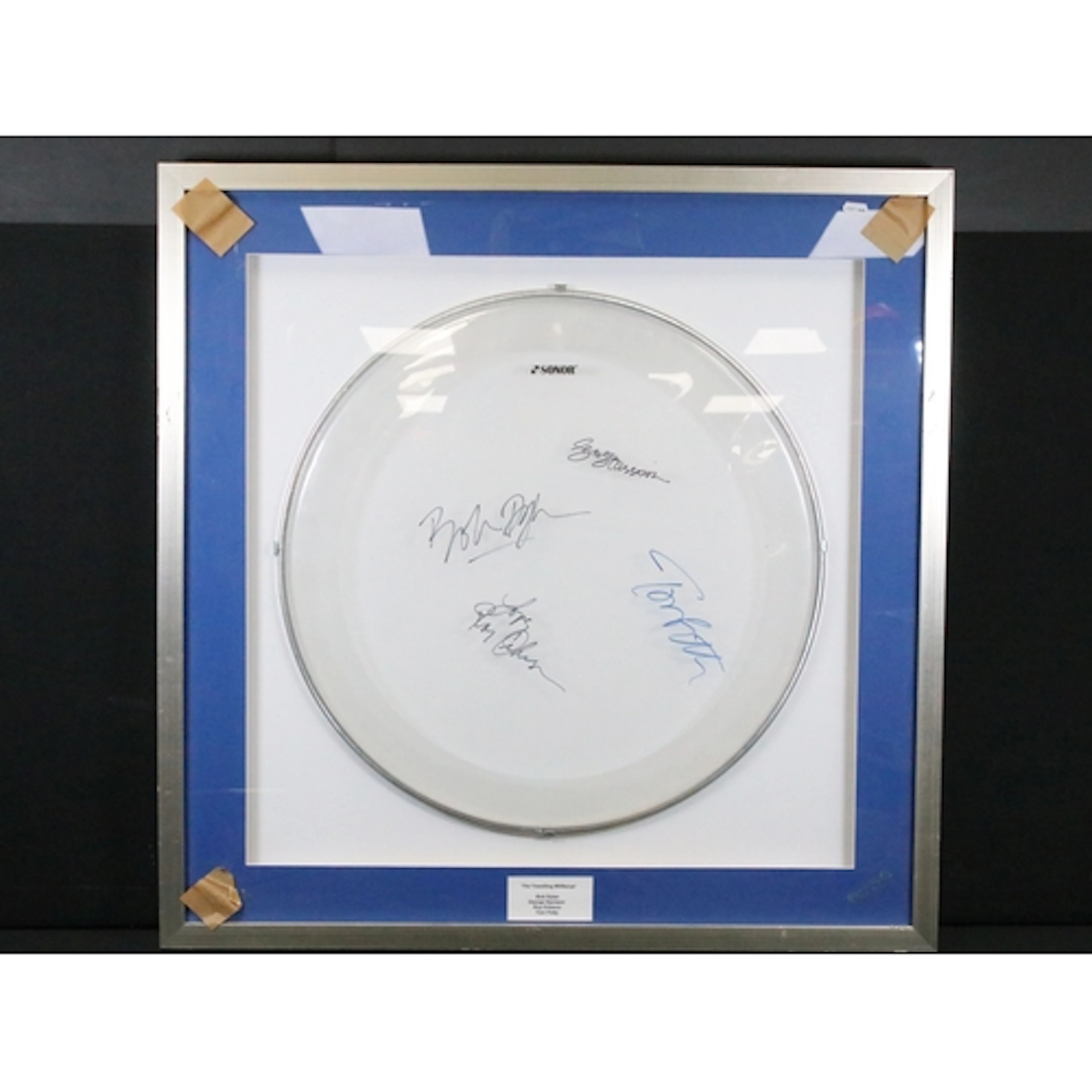 Memorabila / Autographs - A framed and glazed drum skin sign...