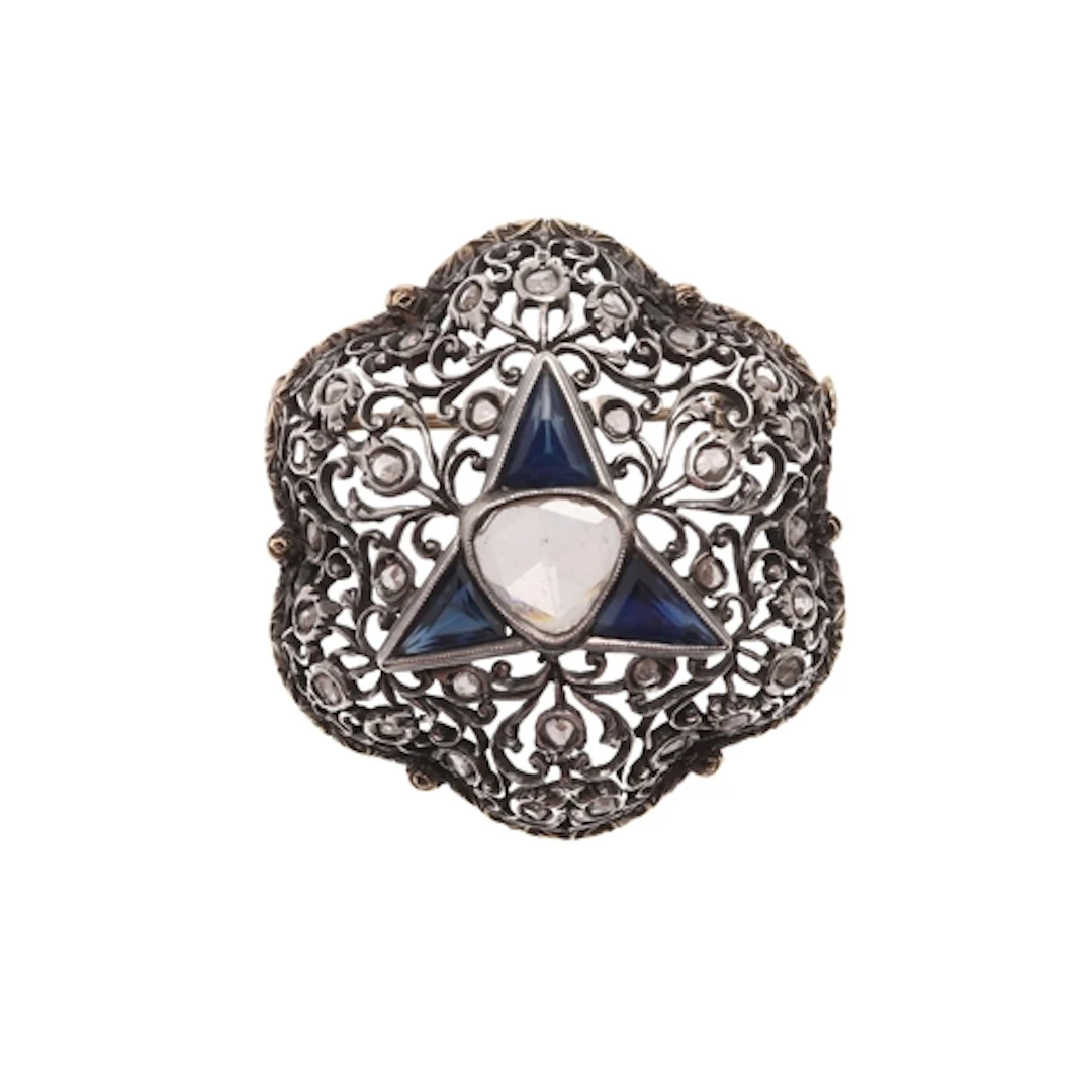 A SAPPHIRE AND DIAMOND BROOCH. the foliate scrolling openwor...
