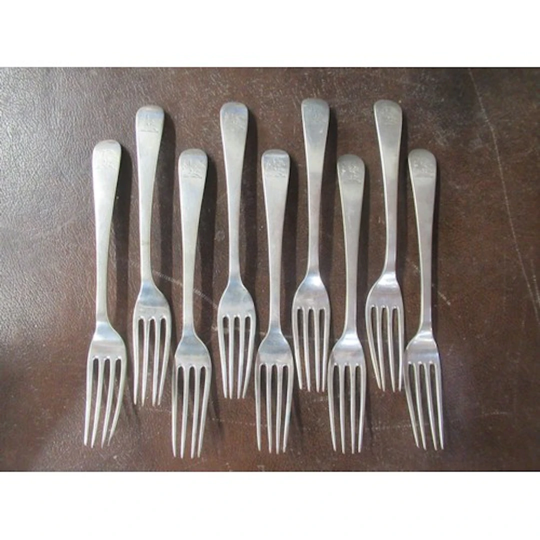 A set of 9 continental white metal dinner forks
