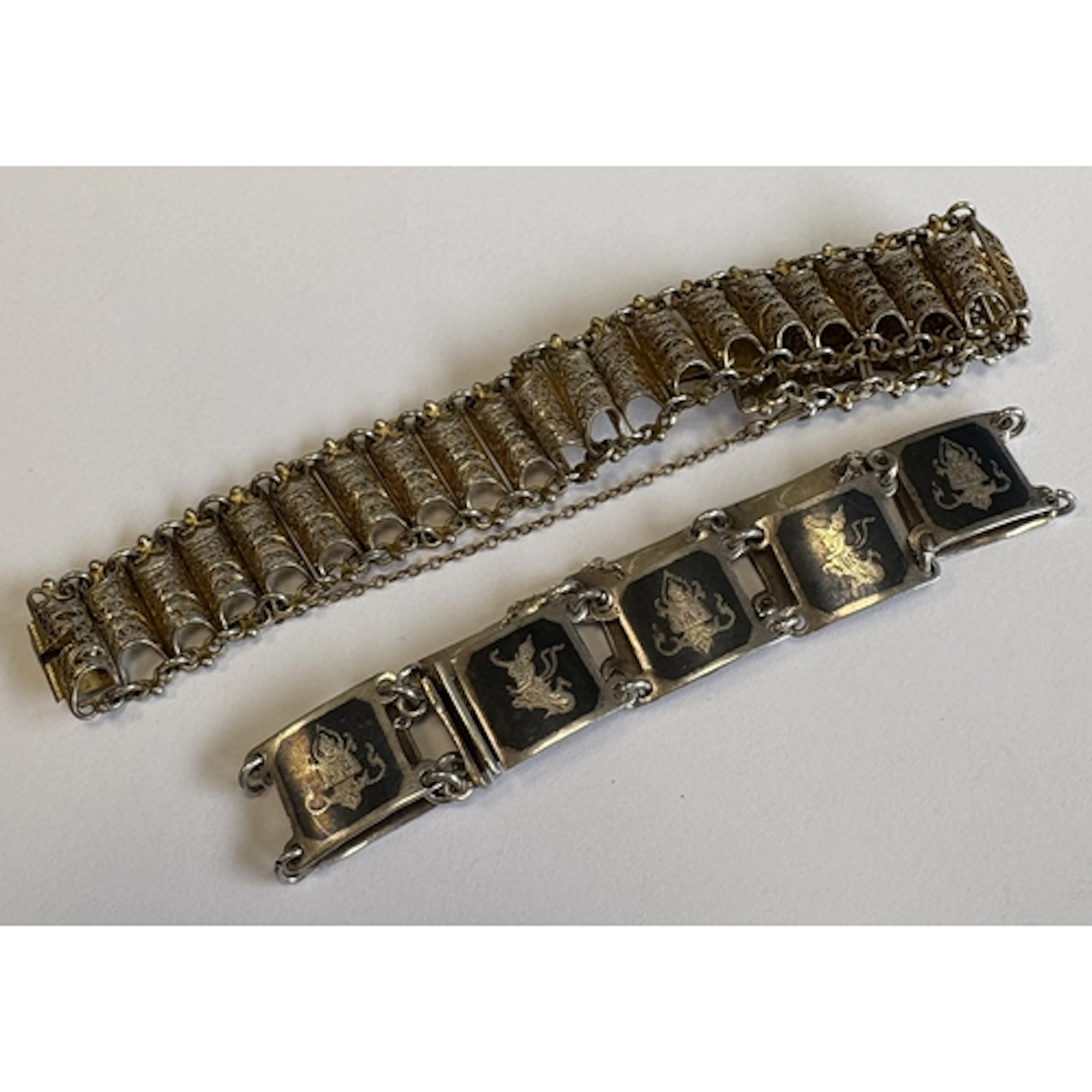 Two Continental silver and niello bracelets with concealed c...