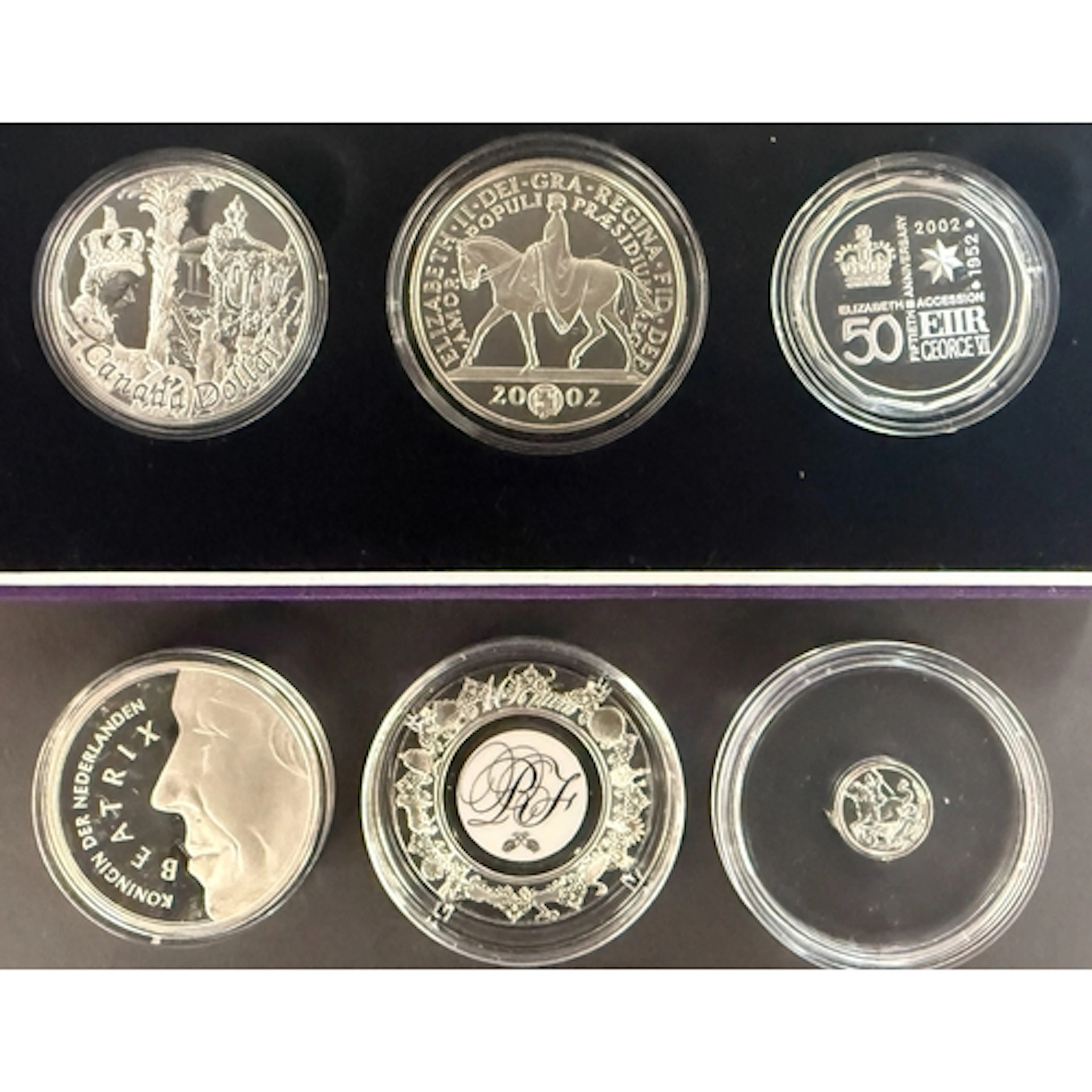 A group of six world silver coins, comprising Canada 2002 $1...