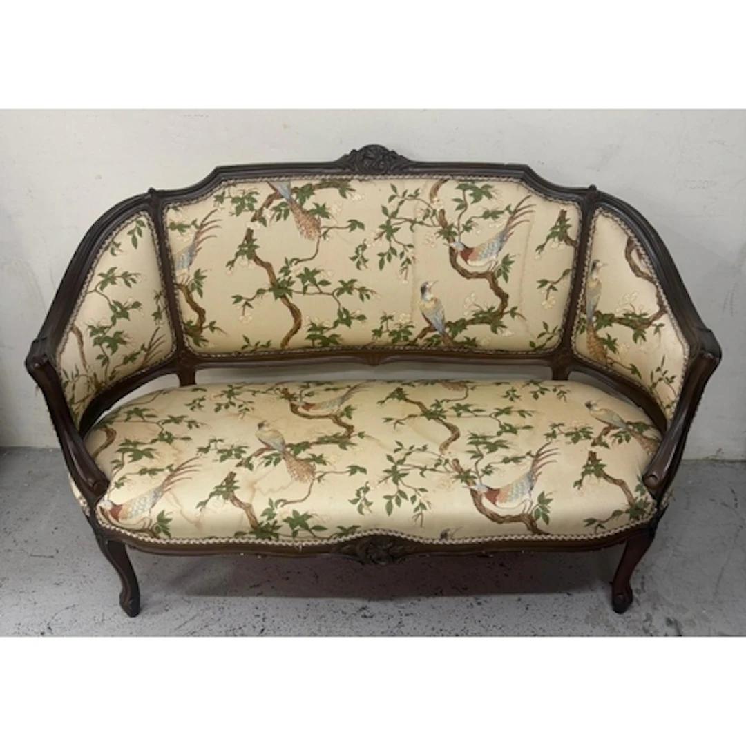 An Edwardian mahogany two seater sofa in a floral upholstery...