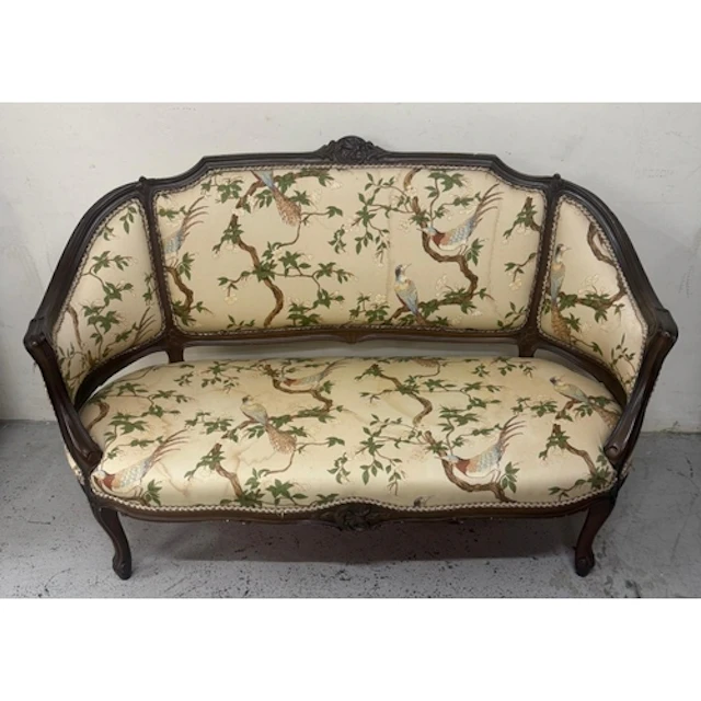 An Edwardian mahogany two seater sofa in a floral upholstery...