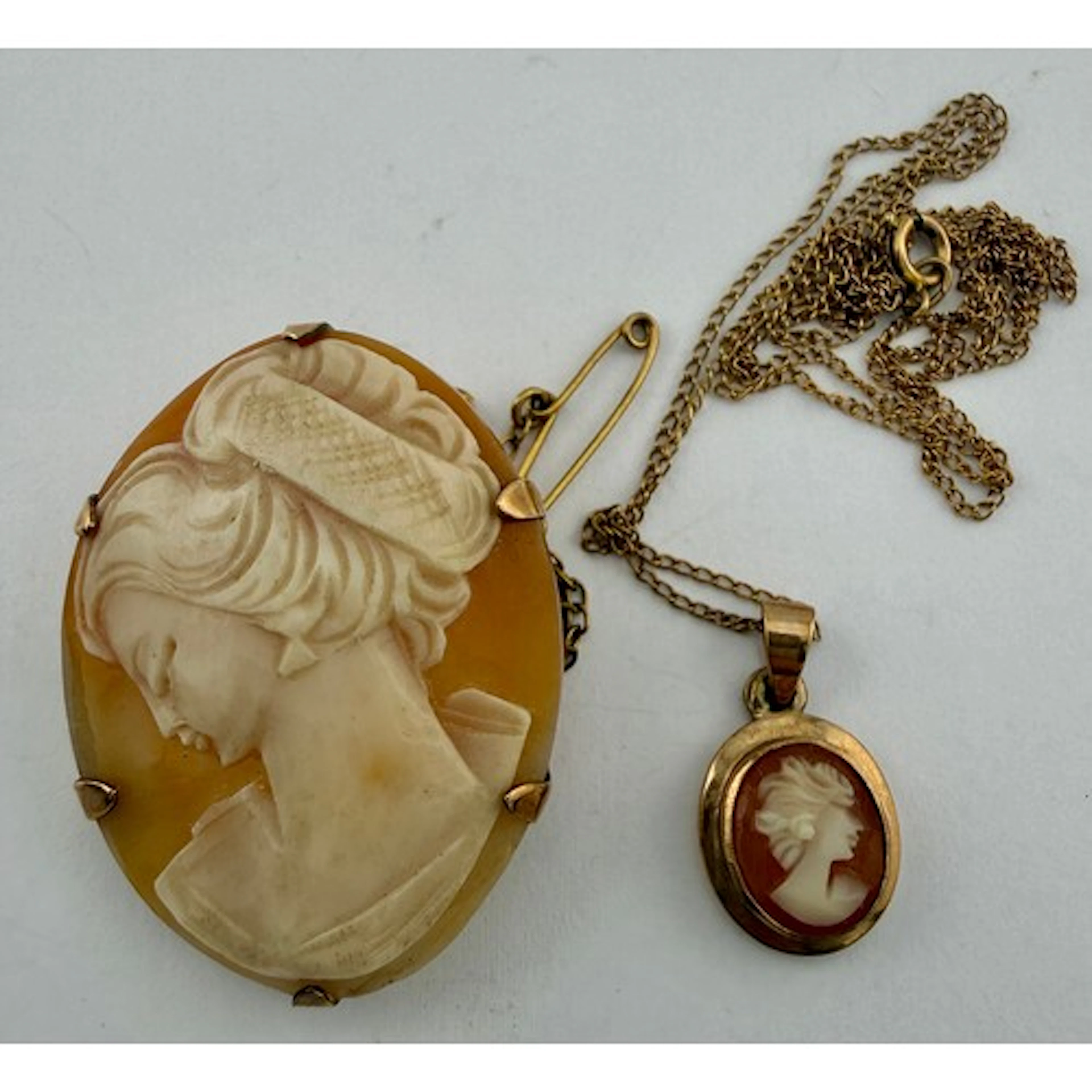 Carved shell cameo brooch and similar pendant, both set in 9...