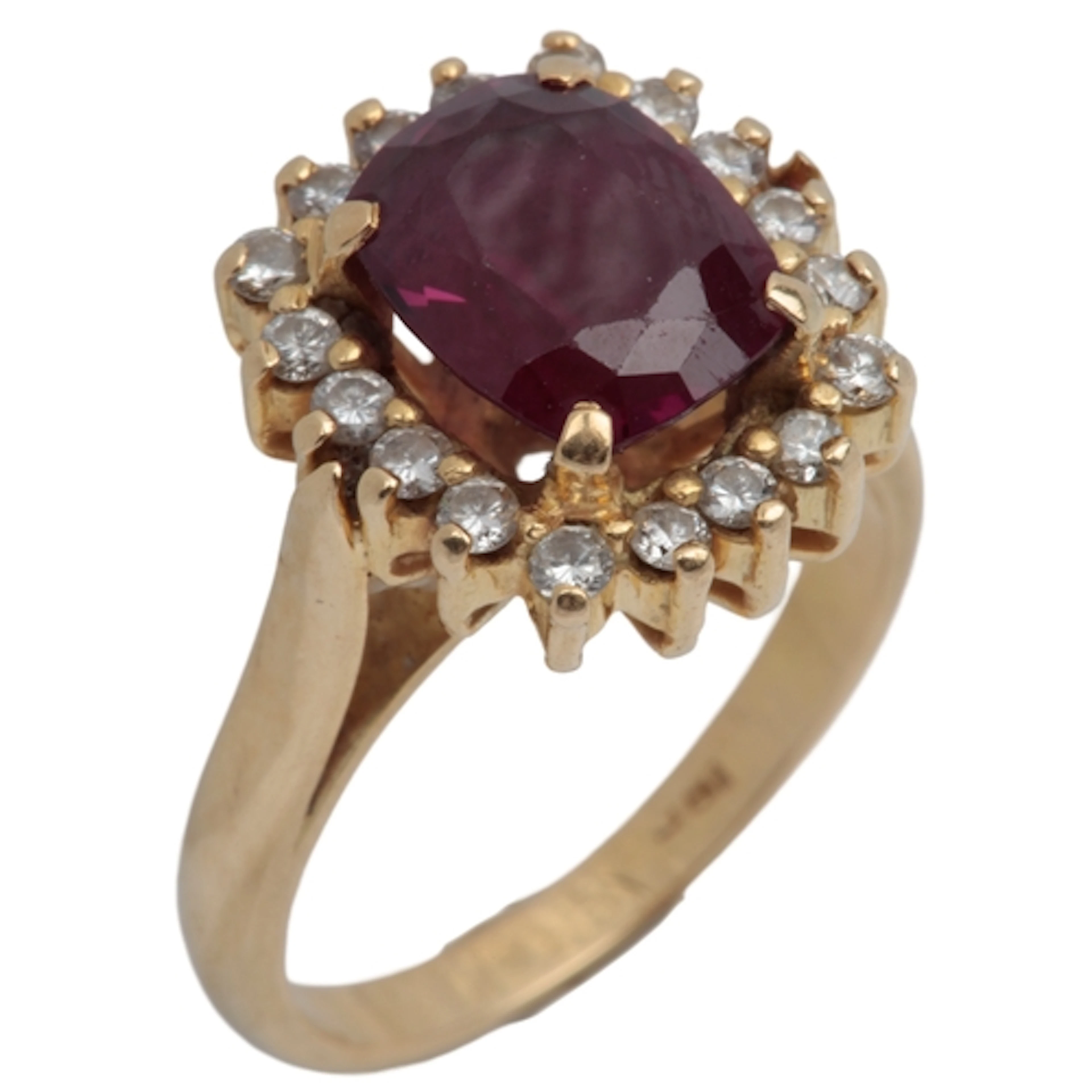 A garnet and diamond cluster ring, claw-set with a cushion-s...