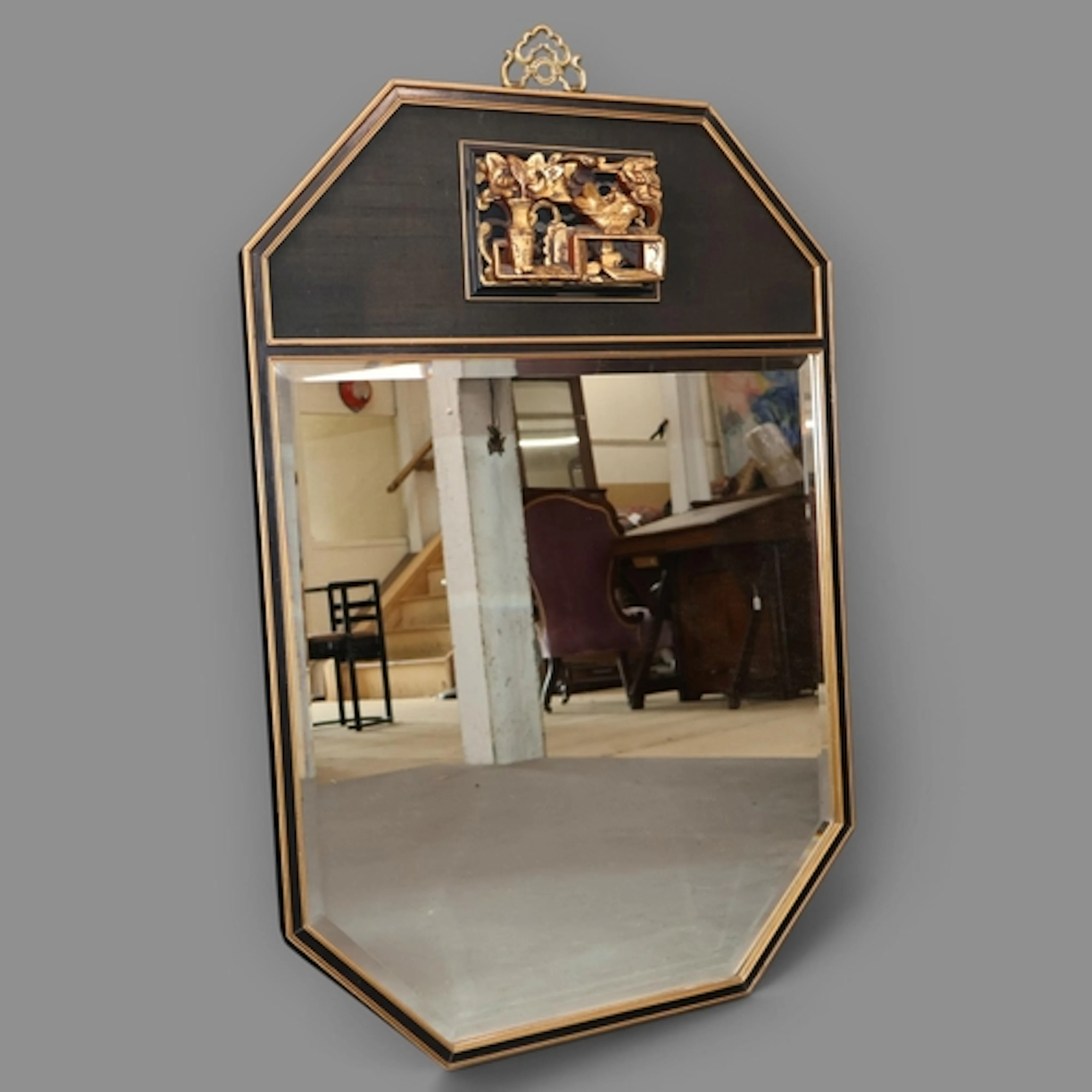 A contemporary Oriental design black painted and bevel edged...