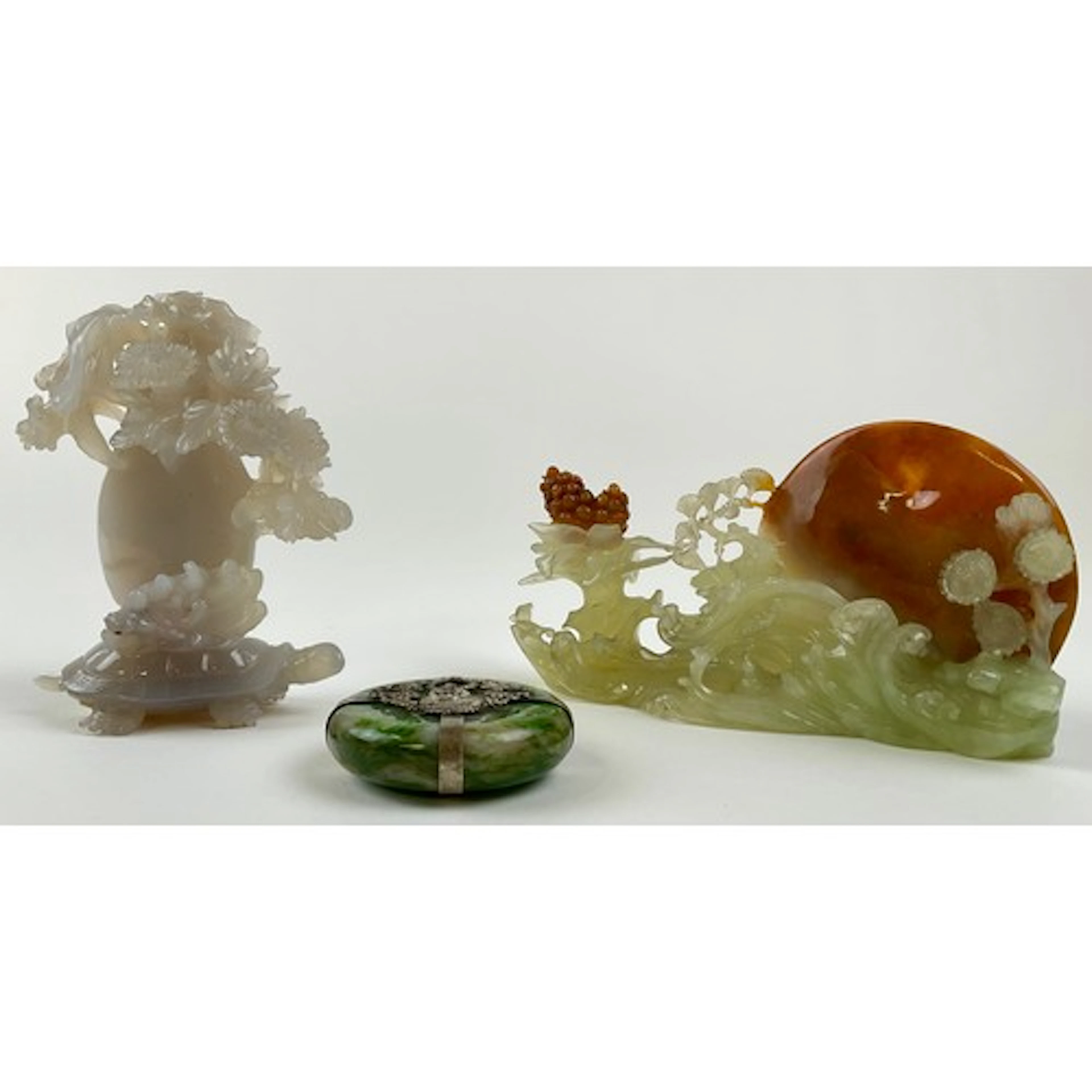 A Chinese jade circular pendant, applied to each side with a...