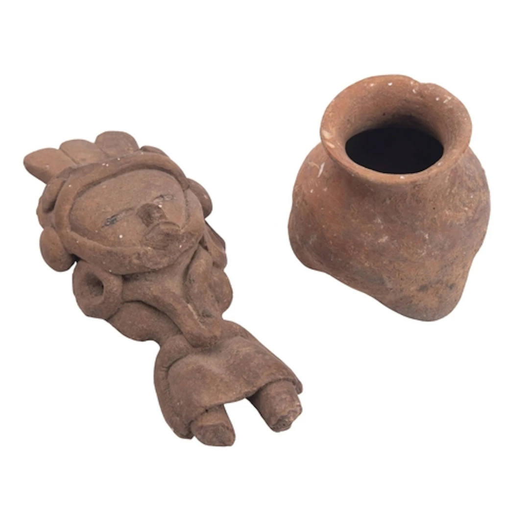 A pre-Columbian style earthenware figurine of stylized human...