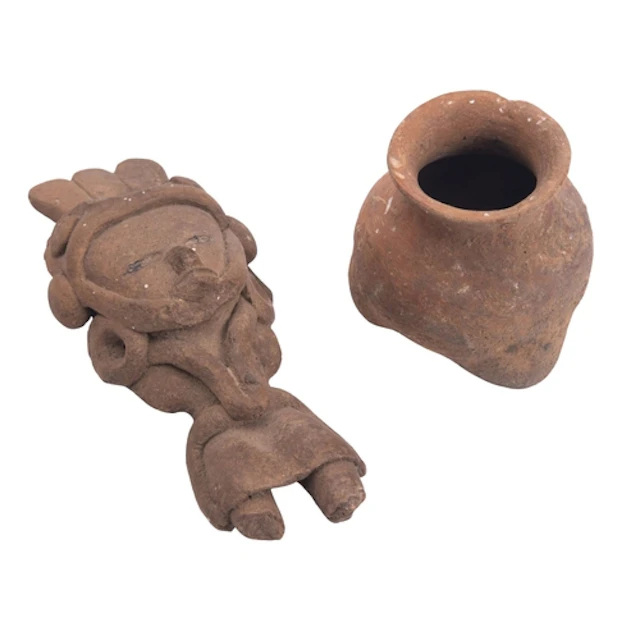 A pre-Columbian style earthenware figurine of stylized human...