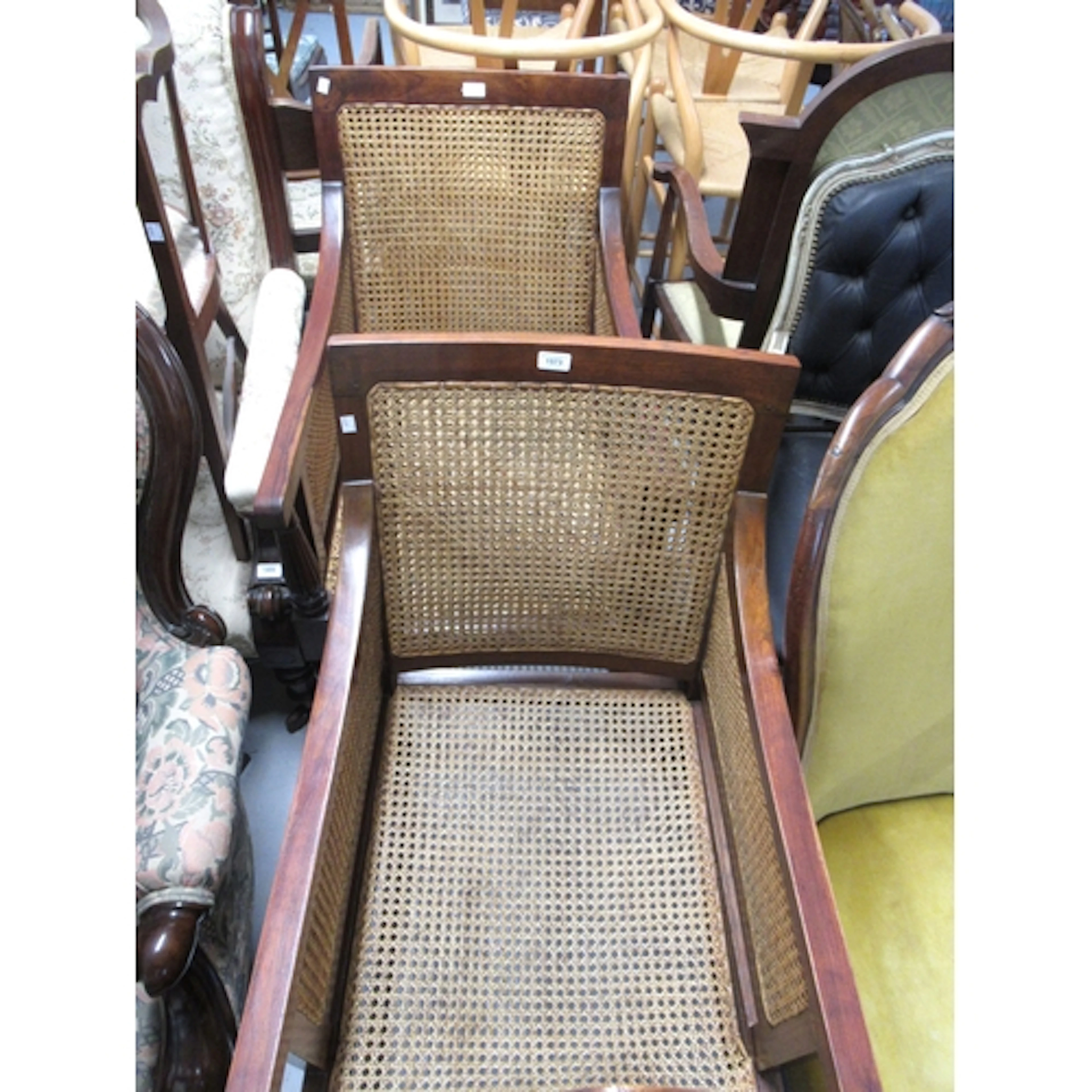 Pair of 20th Century colonial hardwood bergere armchairs, in...
