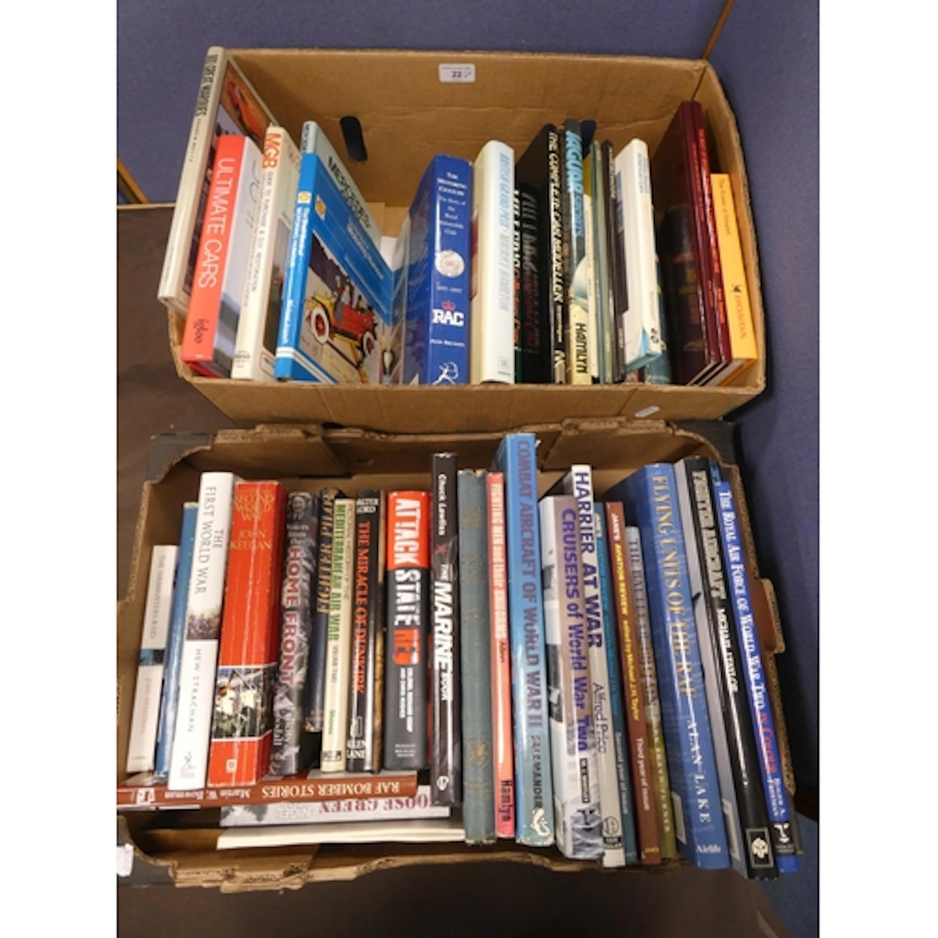 Two cartons containing motoring and military books to includ...
