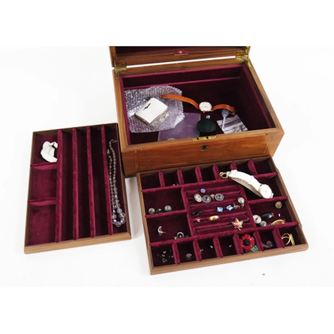 A wooden jewellery case containing a small amount of silver ...