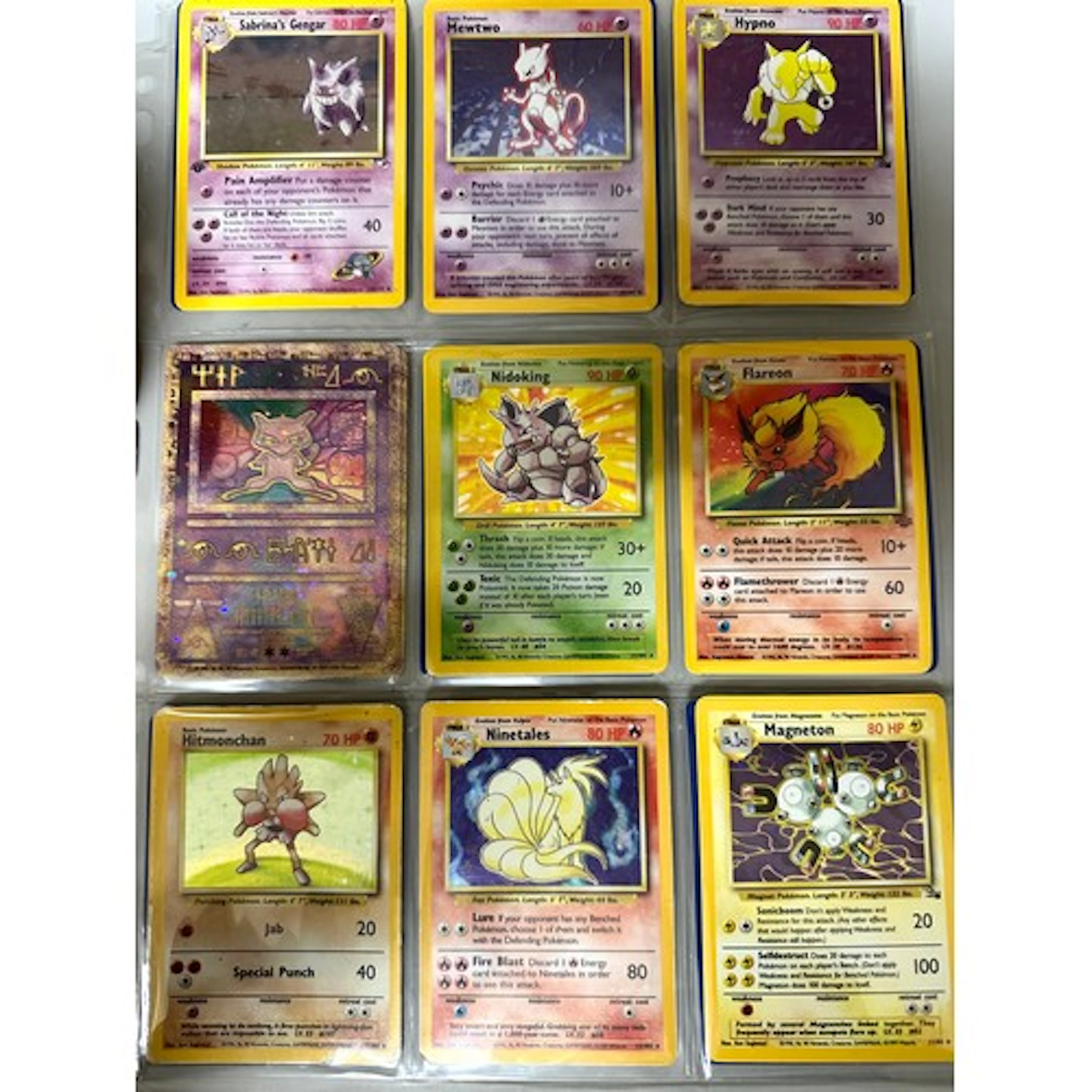 A collection of Pokémon cards, some Holographic, 1990s