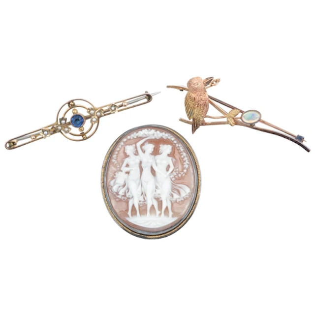 Three brooches, comprising: a gold and opal brooch designed ...