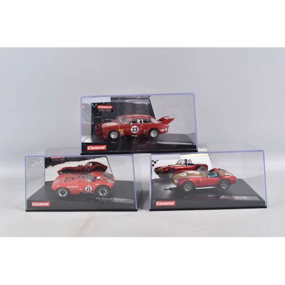 THREE CASED CARRERA EVOLUTION SLOT CARS, these cars have bee...