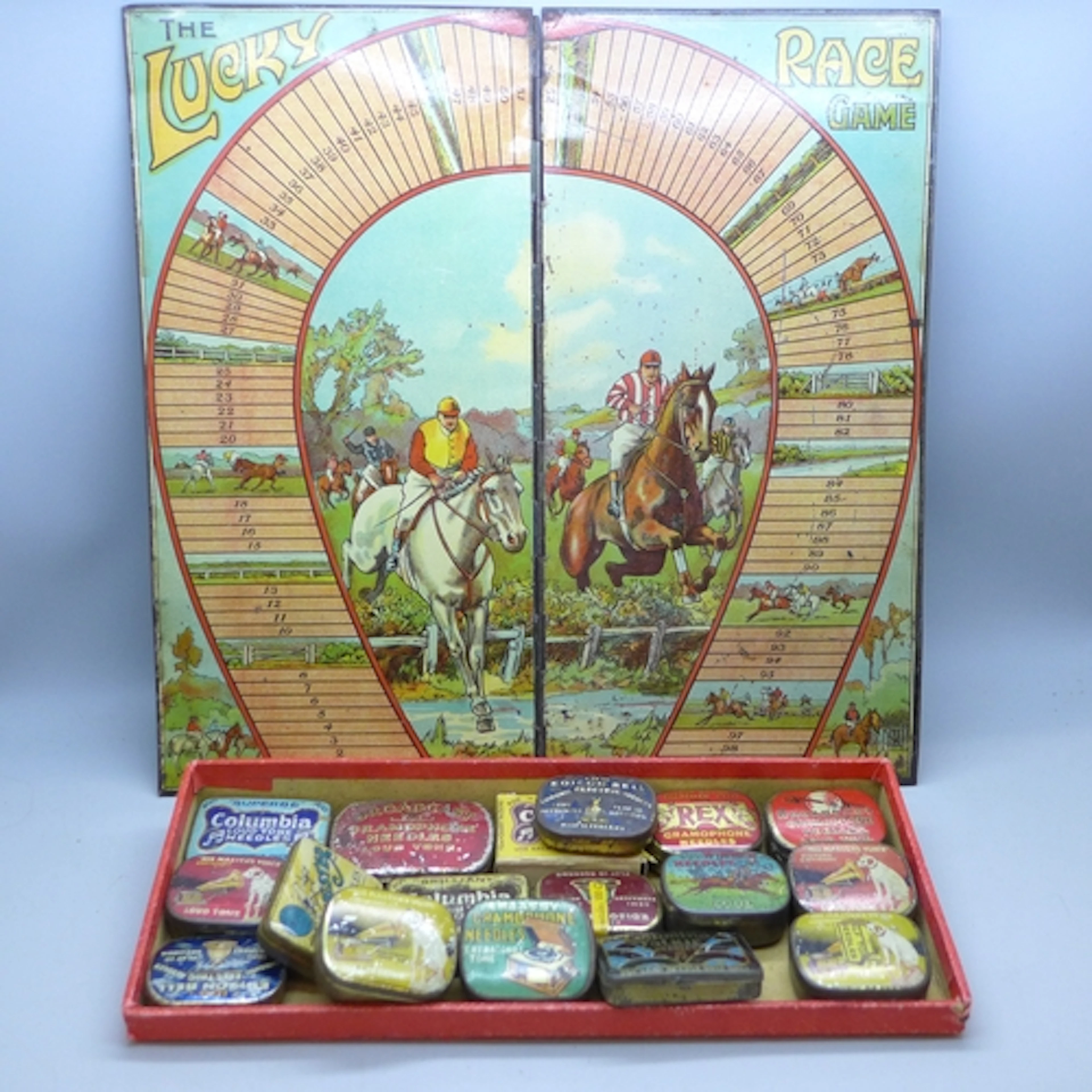 Seventeen vintage needle tins and a tin-plate The Lucky Race...