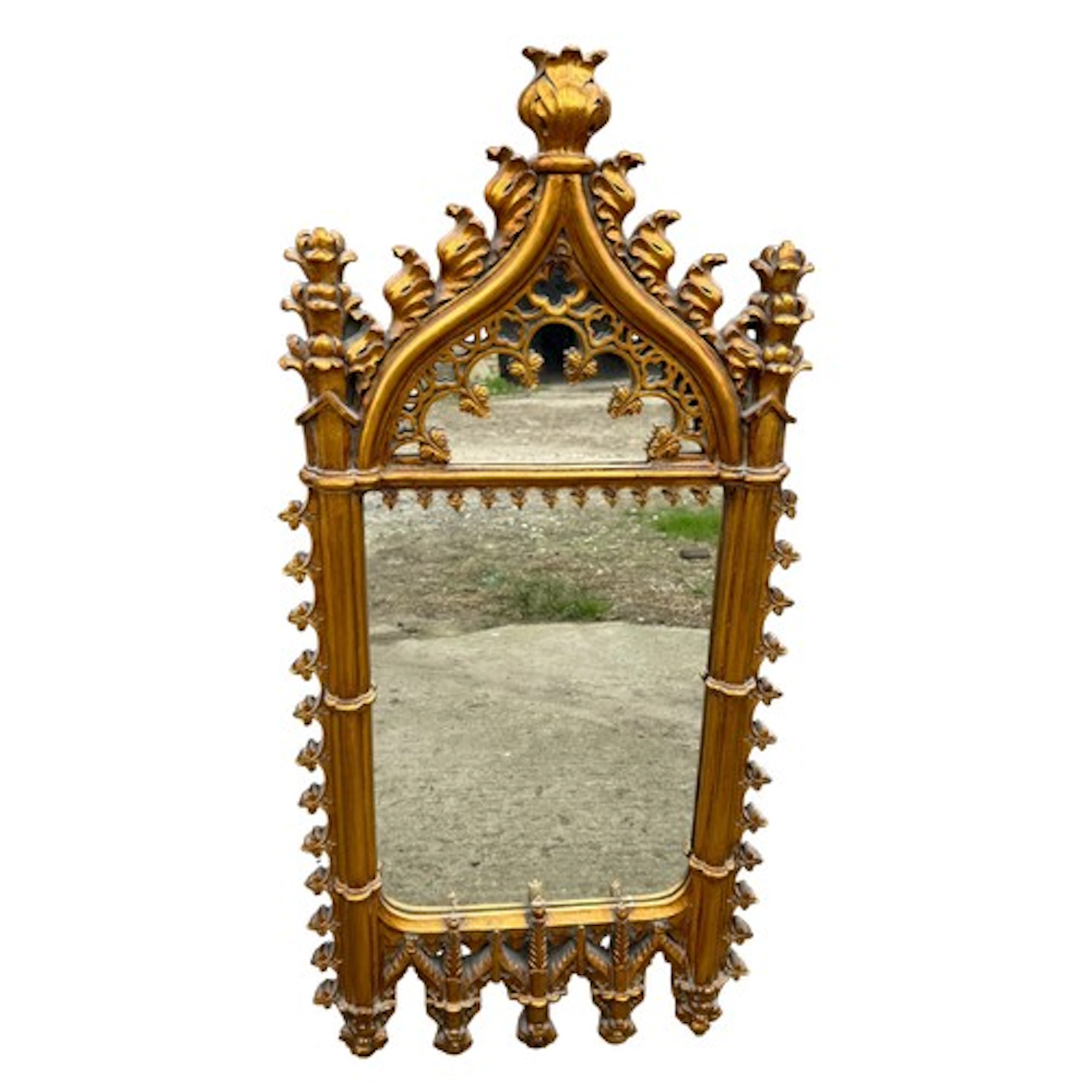 A 20thC gothic style resin gilt framed mirror. 90cm x 43cm
