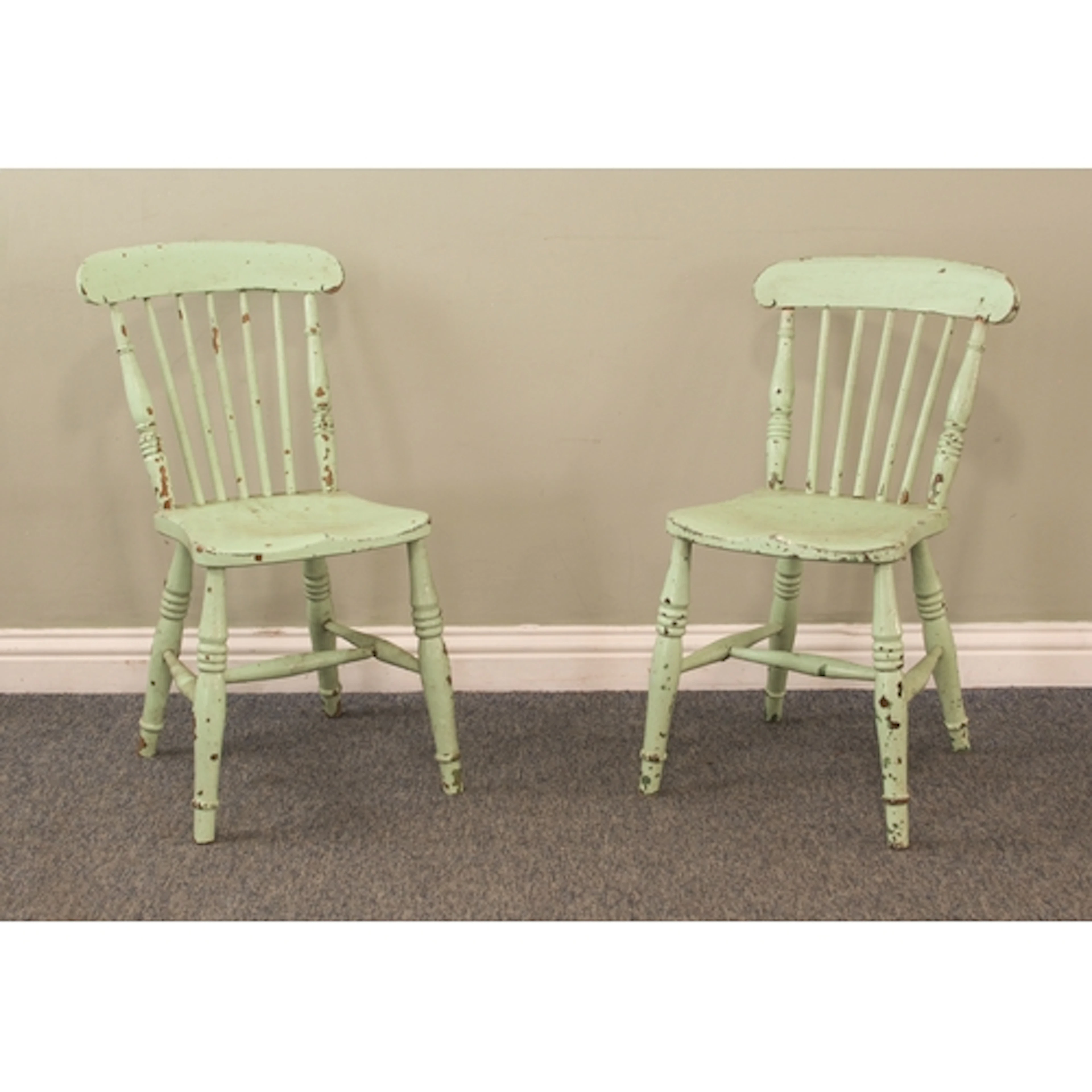 A pair of peppermint-green painted spindle back kitchen chai...