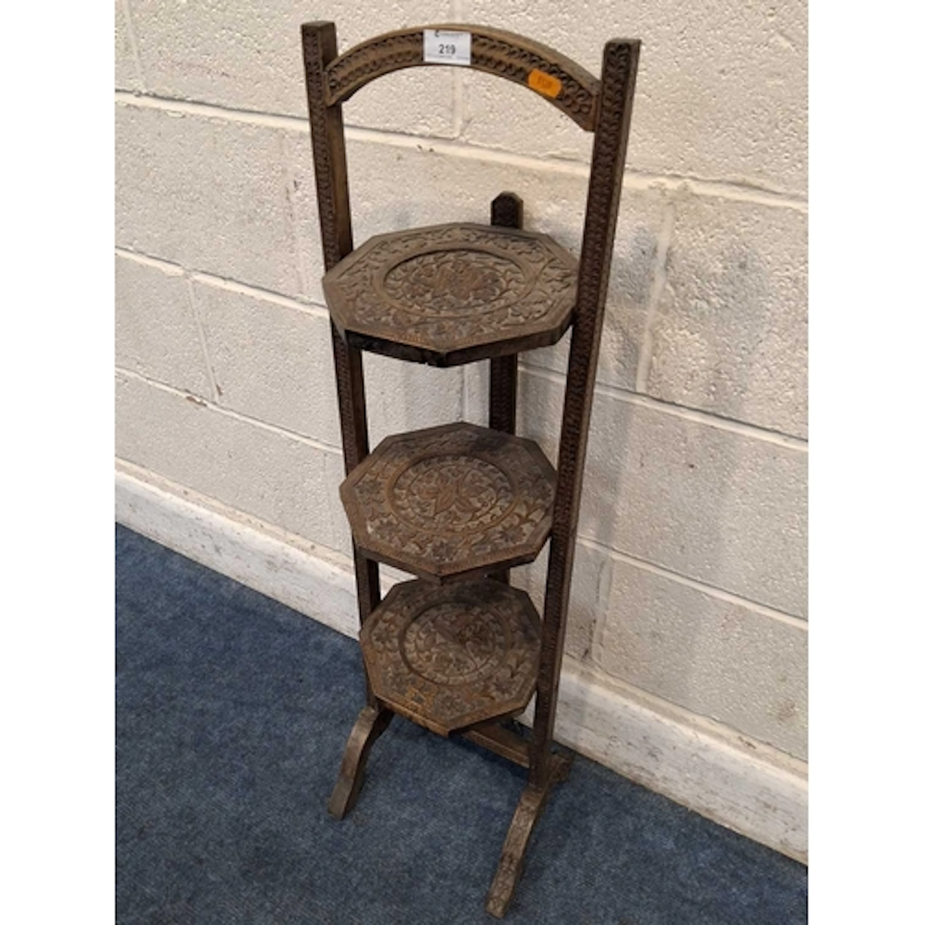AN EARLY 20TH CENTURY CARVED OAK THREE TIER FOLDING CAKE STA...