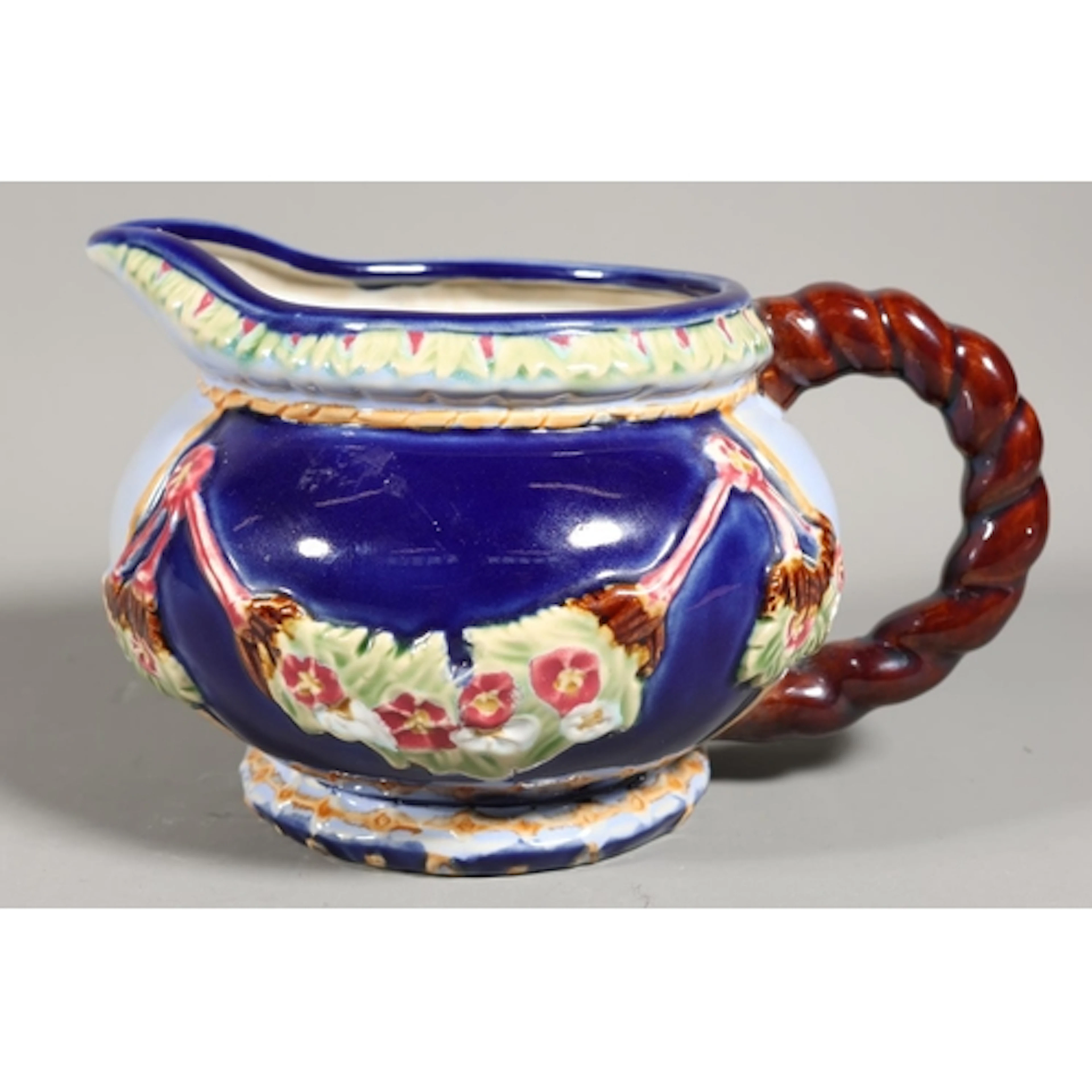 Majolica style ceramic embossed pitcher, 14cm tall.