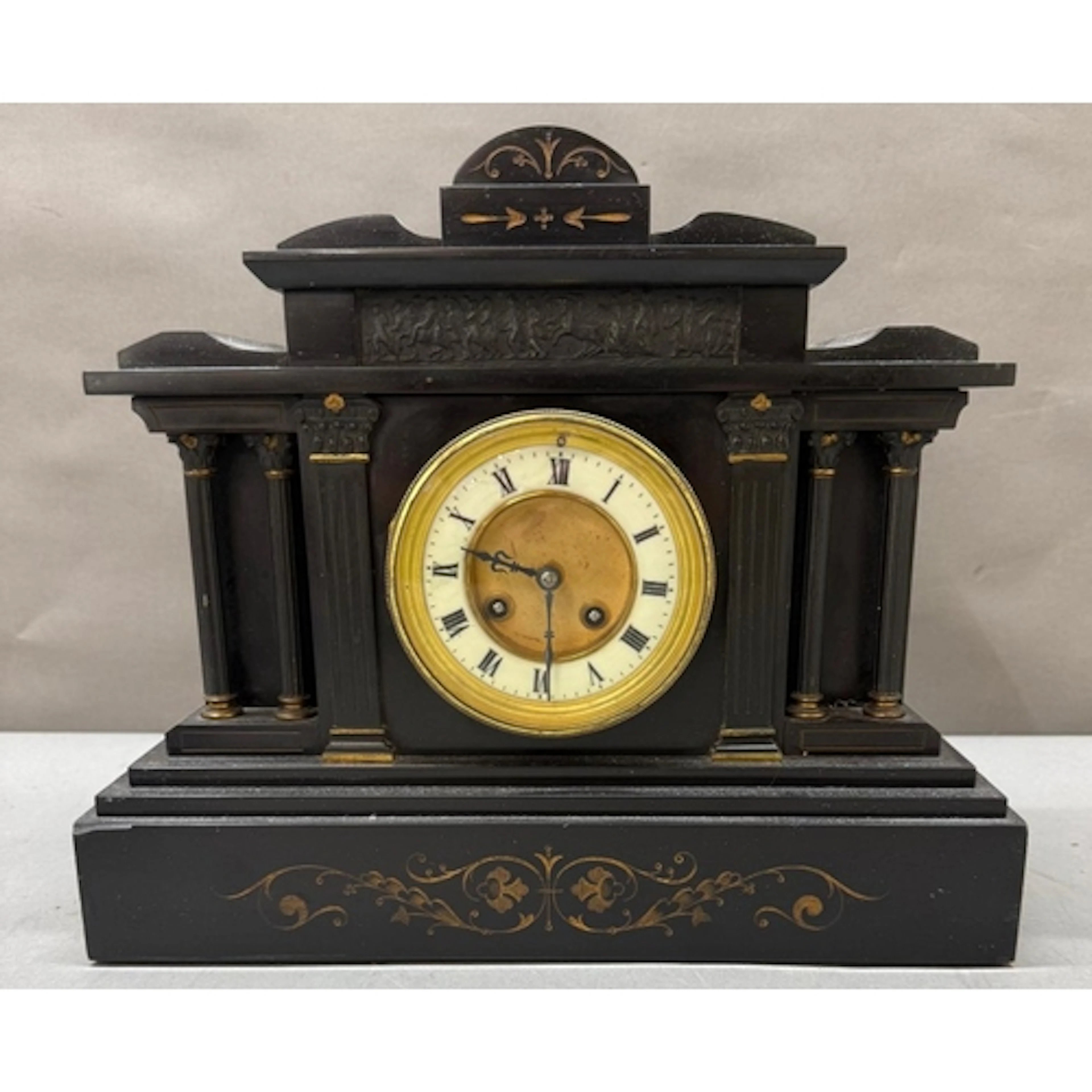 An eight day slate mantel clock with enamel face and Roman n...