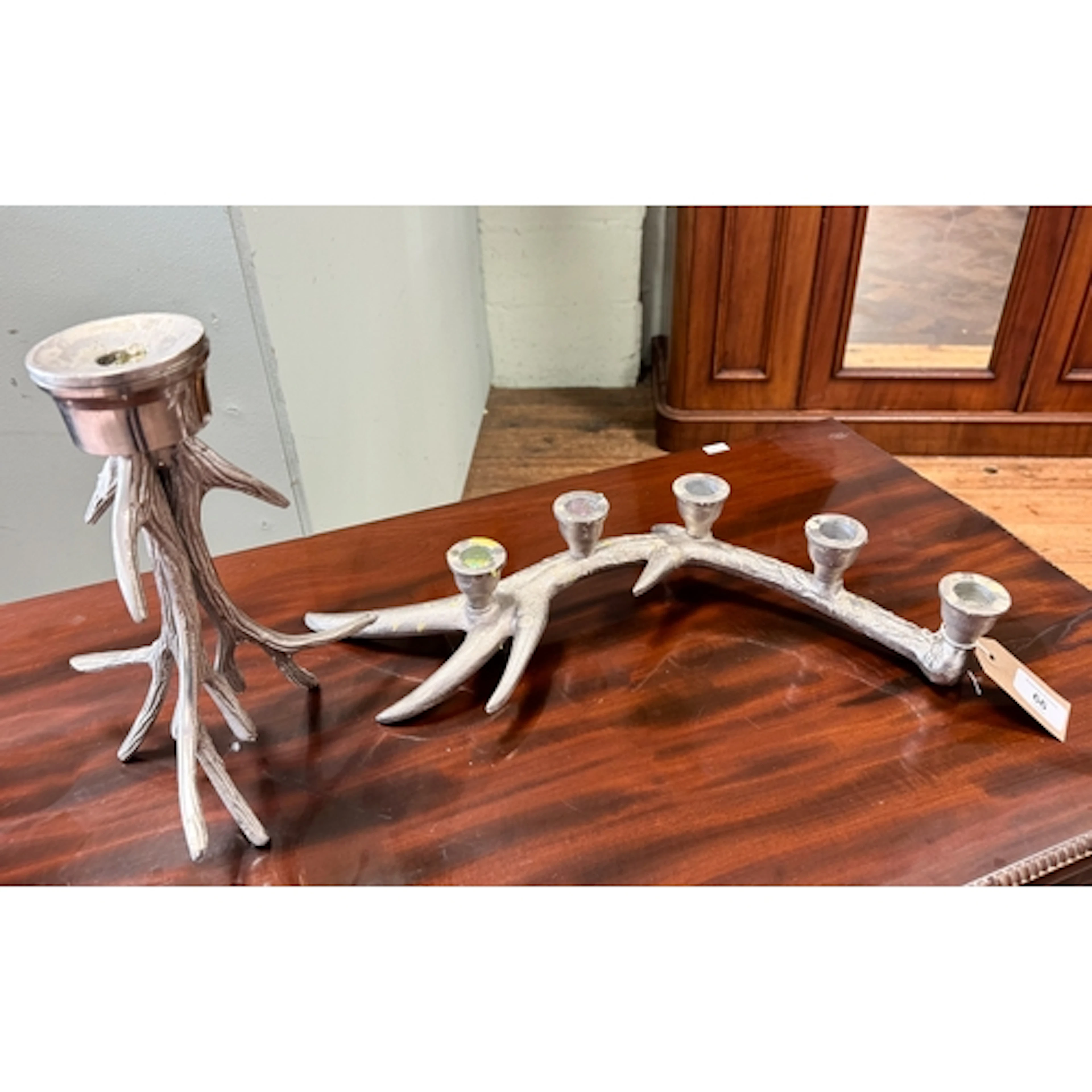 A silver plated aluminium antler style candle stick and an a...