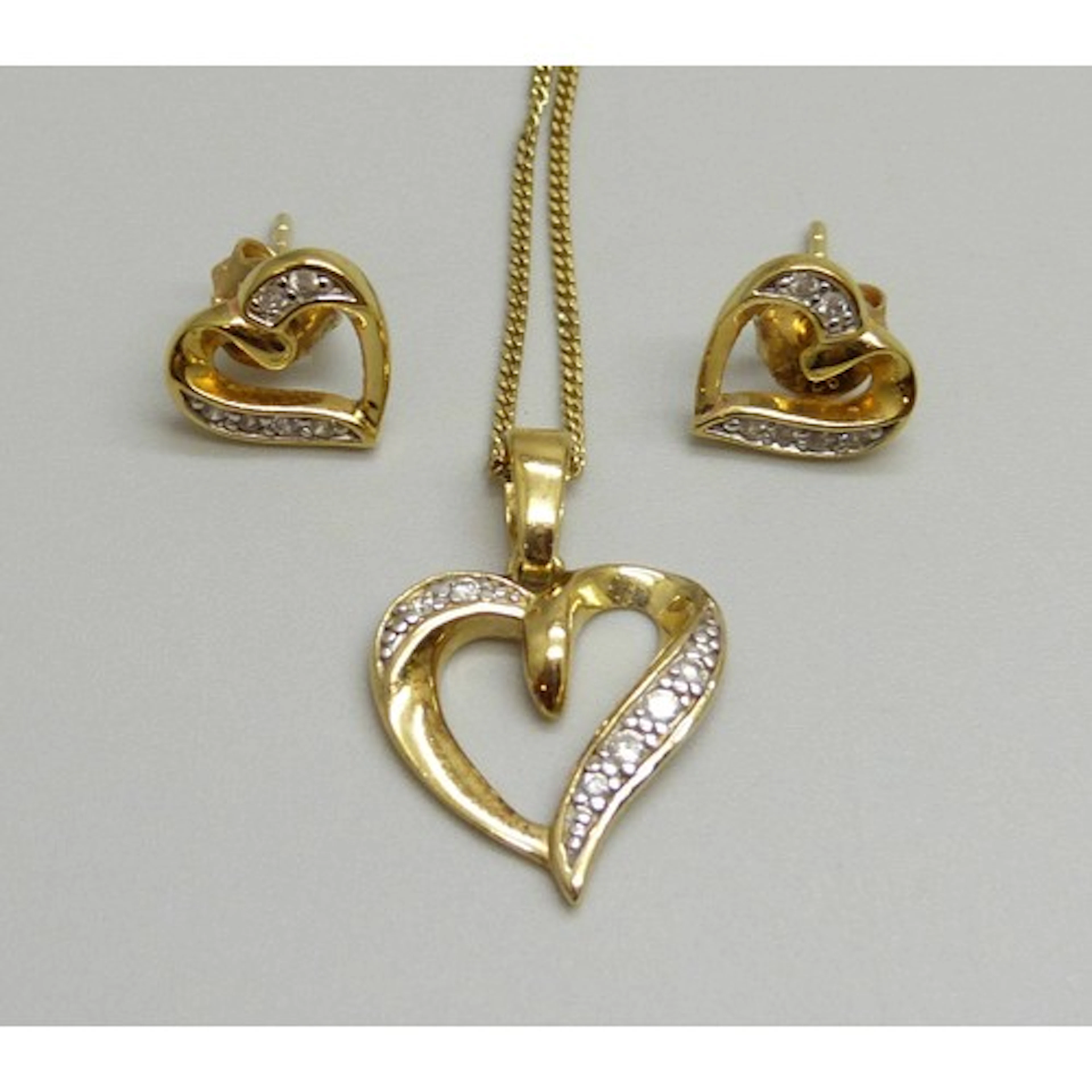 A silver gilt and cubic zirconia matching heart pendant and ...