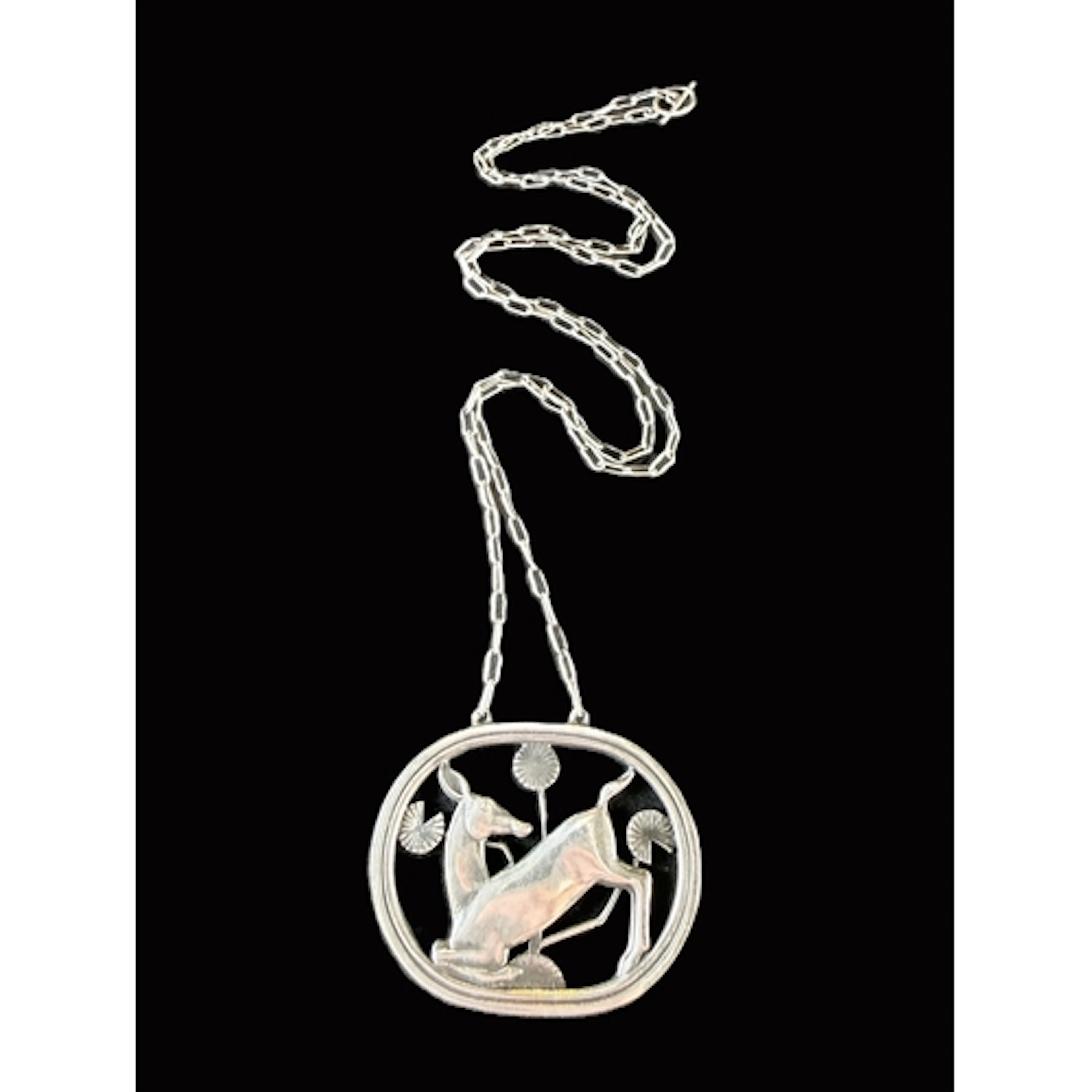 Georg Jensen: an oval silver openwork pendant 'Kneelin...