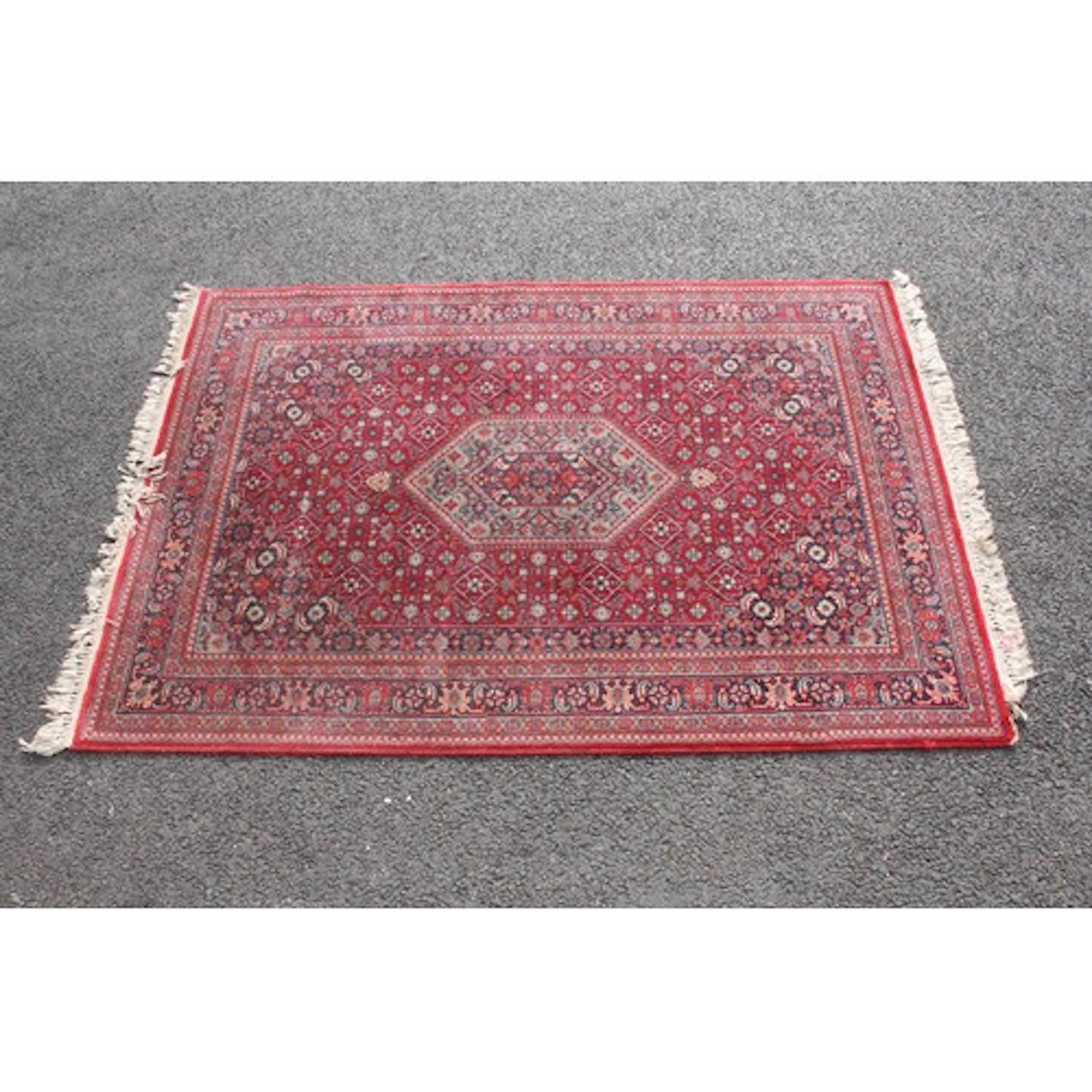 Hand-knotted Persian Mashad rug, of red-ground having blue a...