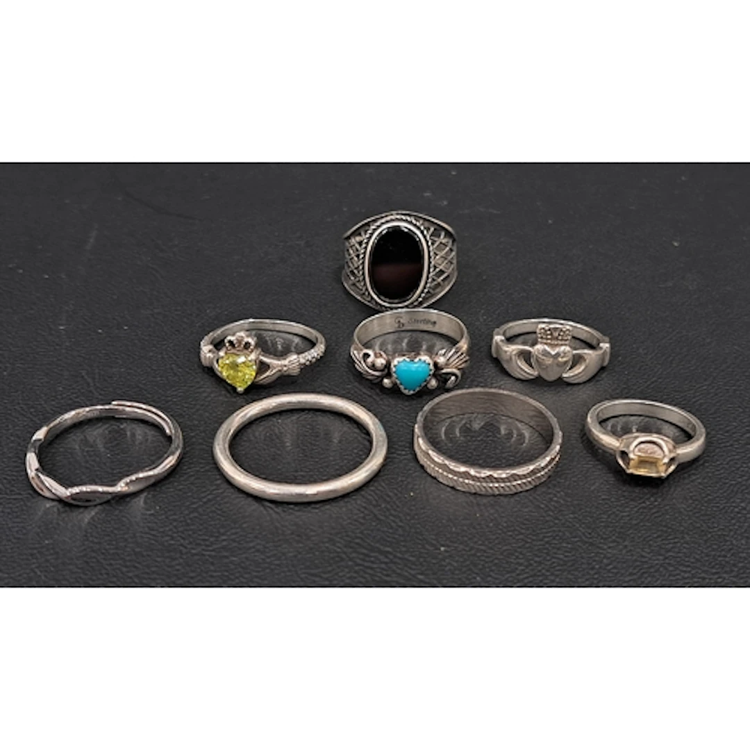 EIGHT SILVER RINGS including turquoise, black onyx and CZ se...