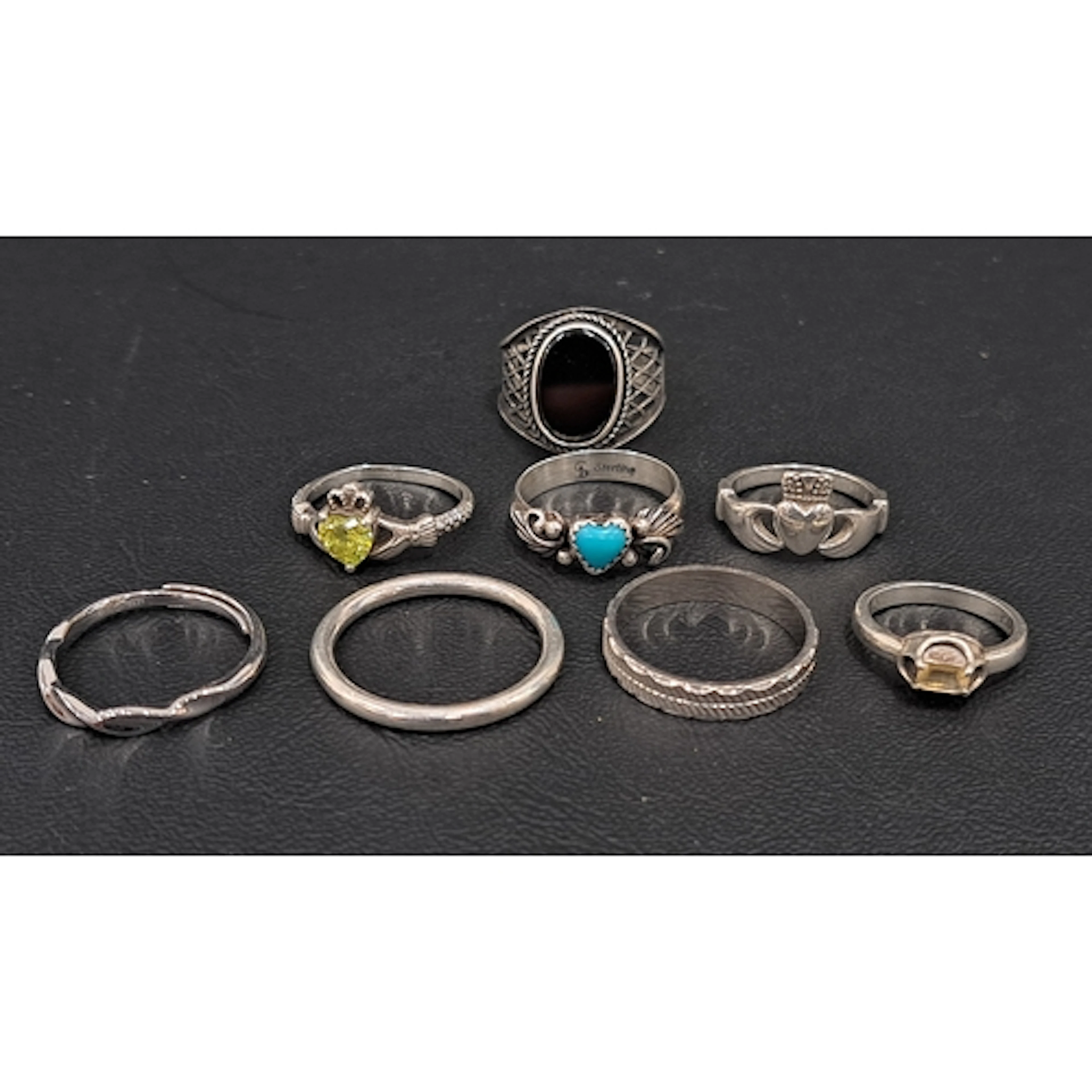 EIGHT SILVER RINGS including turquoise, black onyx and CZ se...