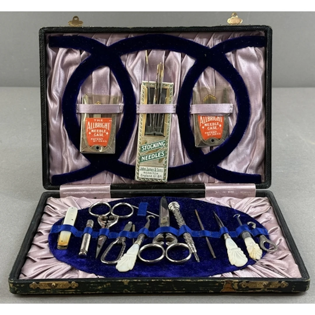 Decorative Arts: a cased mother of pearl handled sewing set,...