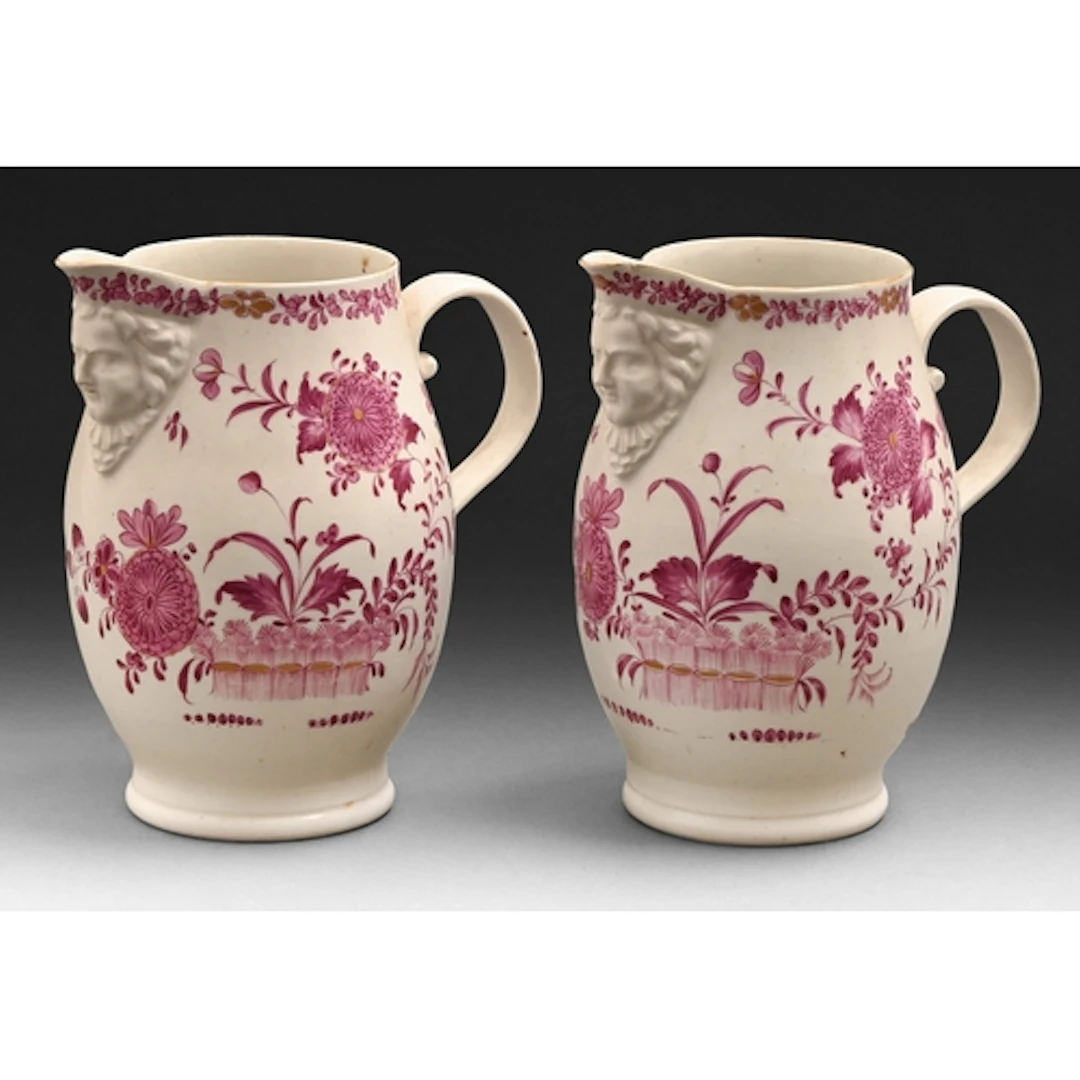 A pair of Derby mask jugs, c1760, painted in puce monochrome...