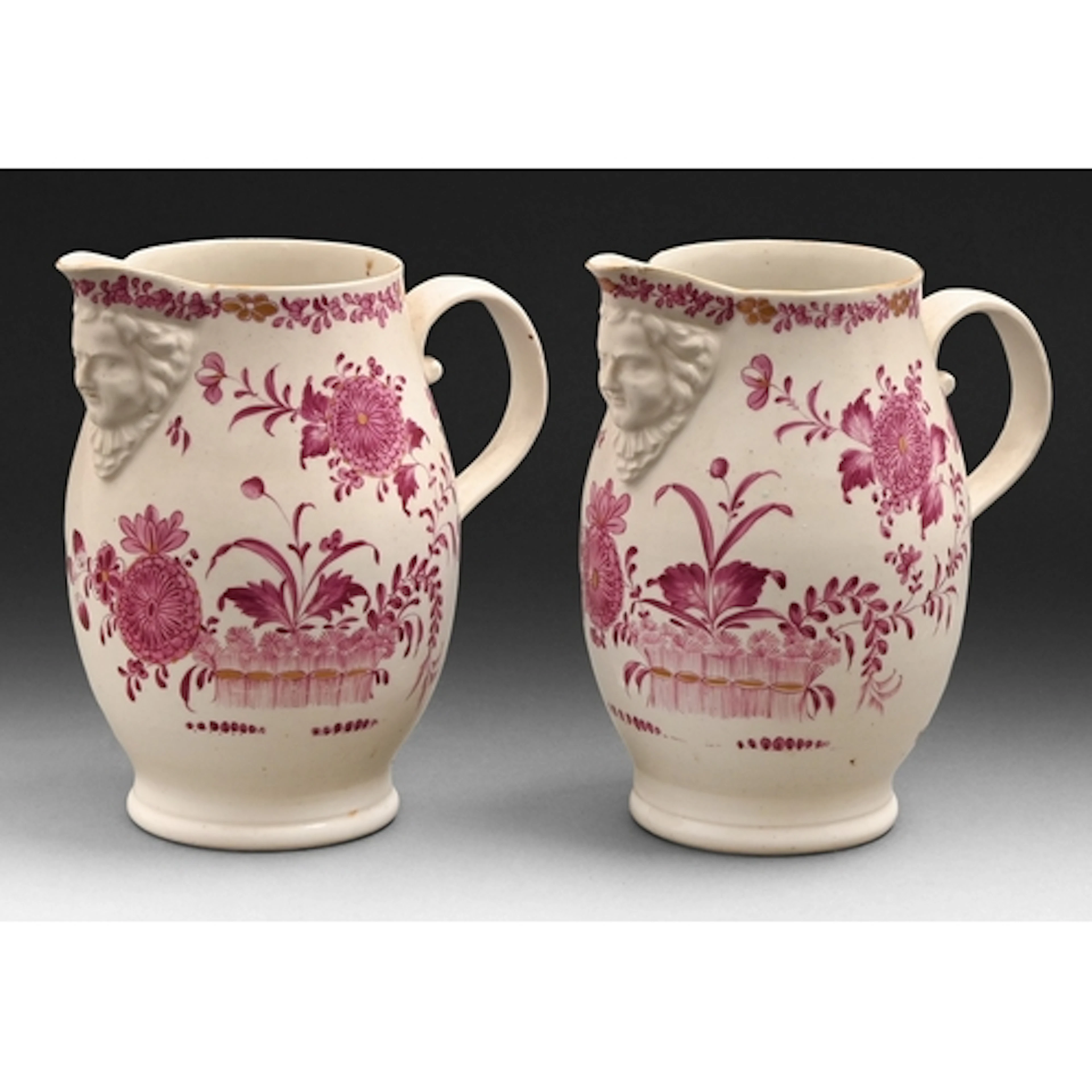 A pair of Derby mask jugs, c1760, painted in puce monochrome...