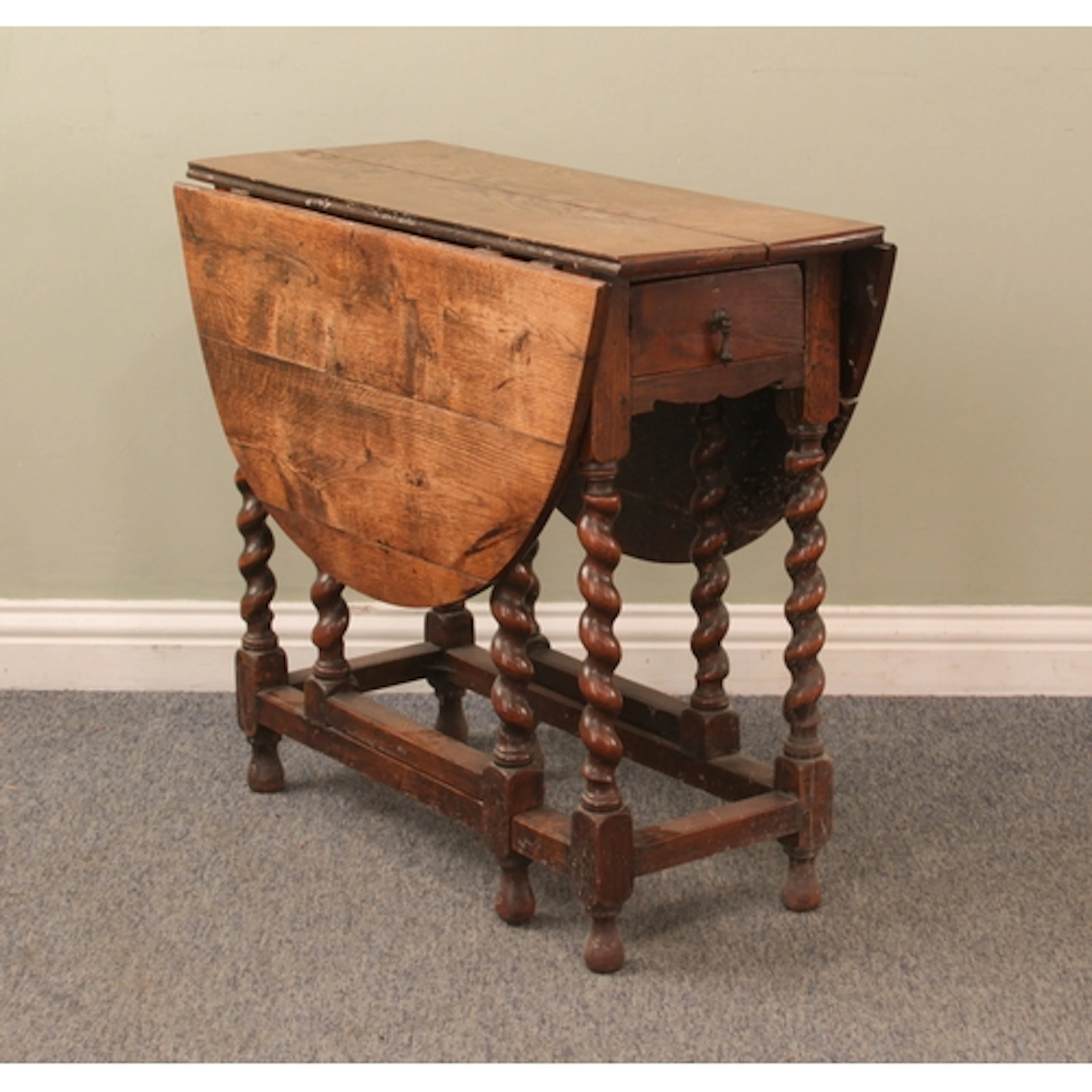 An antique oak oval gateleg table - with a single end drawer...