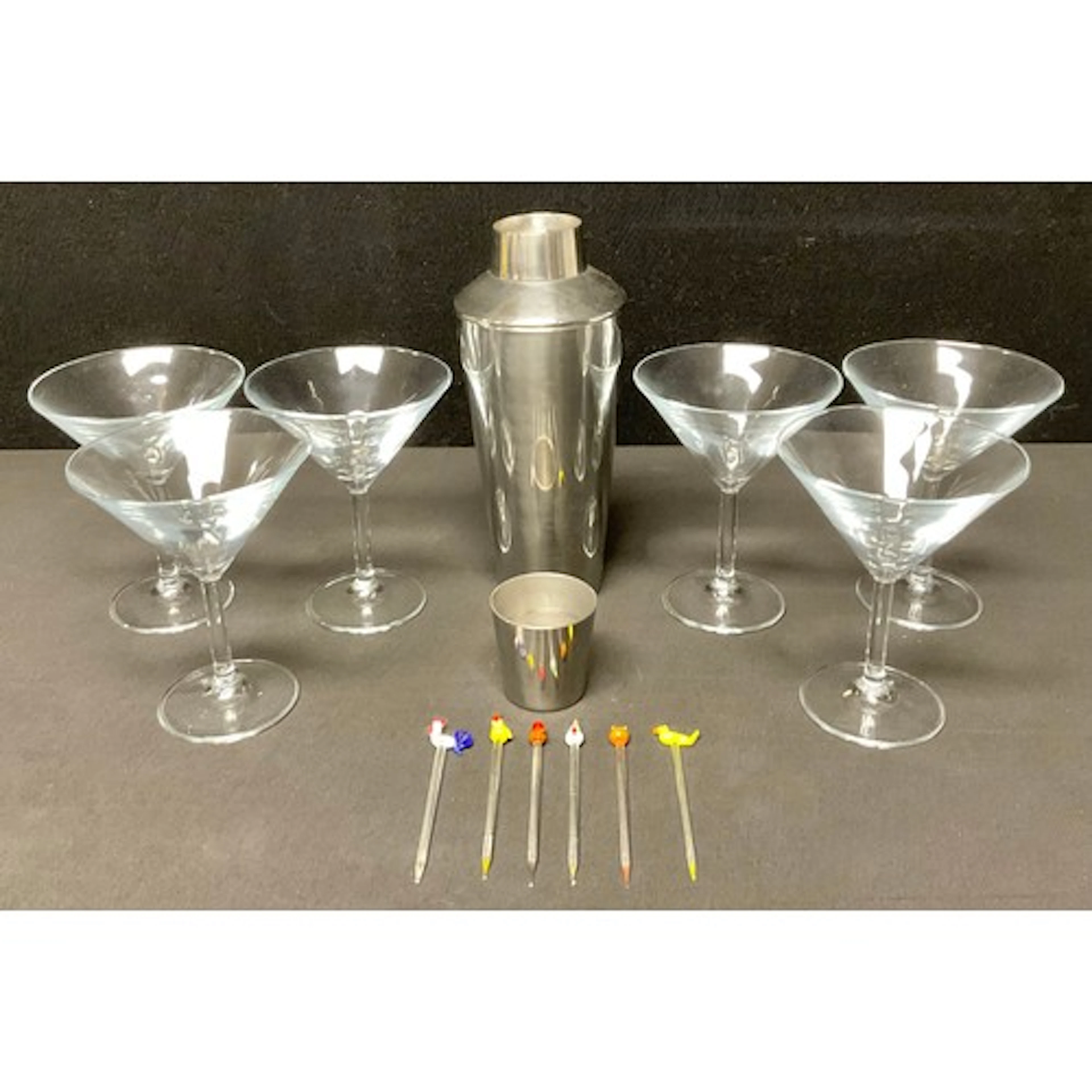 A stainless steel cocktail shaker; a set of six Martini glas...