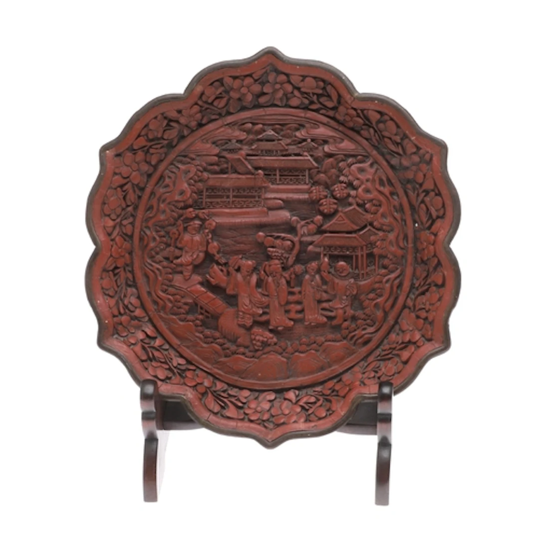 CHINESE CINNEBAR LACQUER PLATE. A wall plate of lobed shape,...