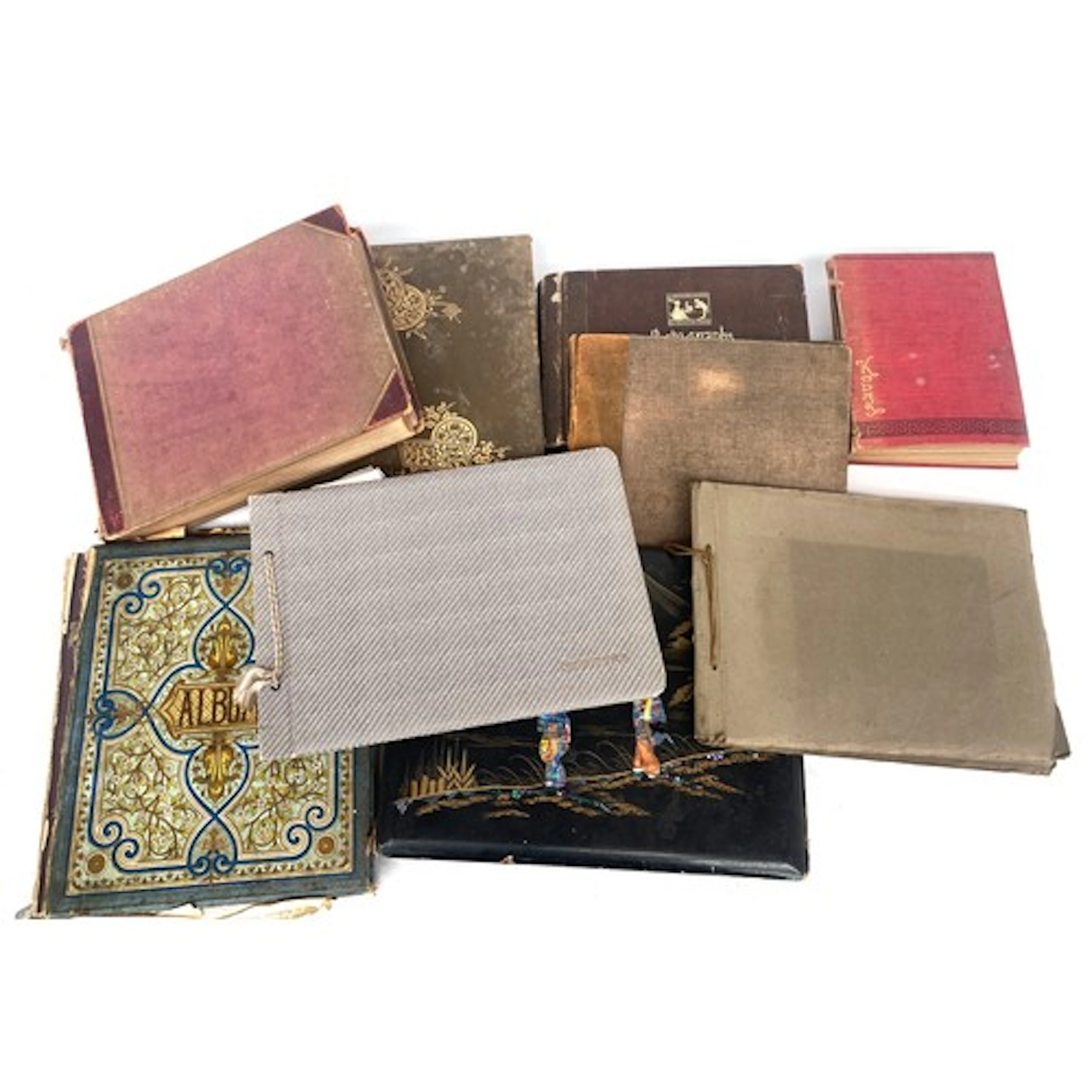 PHOTOGRAPH ALBUMS. Nine. Some with postcards. Two albums are...