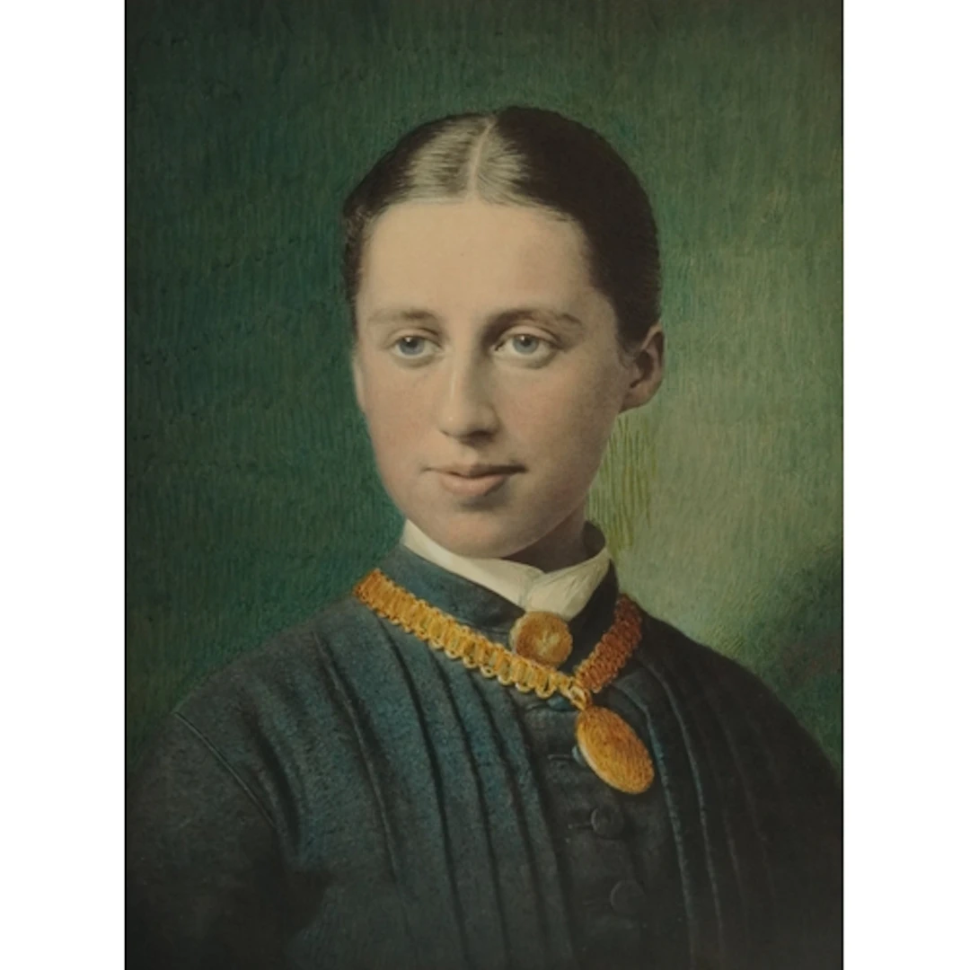 Head and shoulders portrait of a young female wearing a gold...