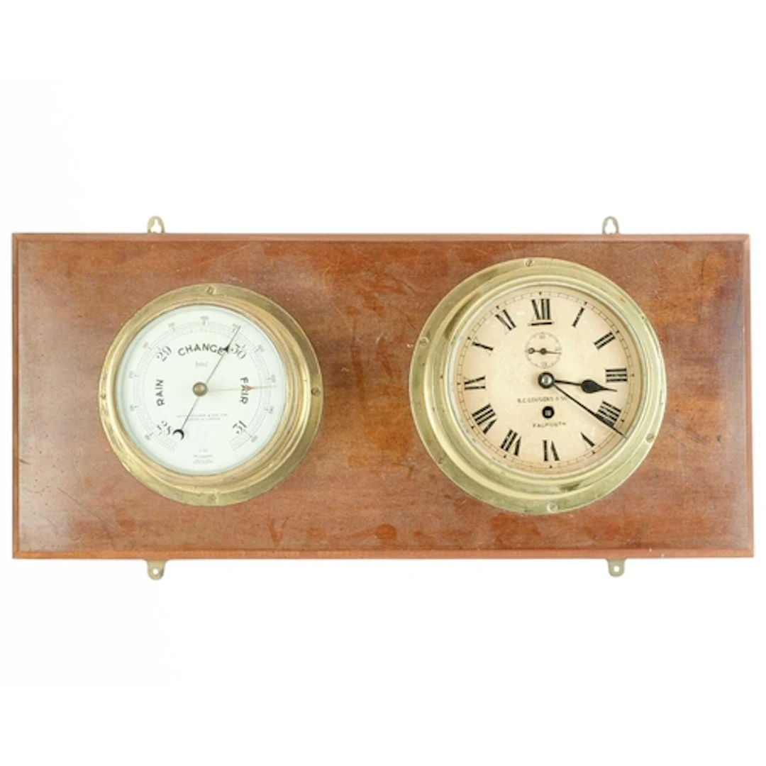 A brass ship's bulkhead clock. The dial signed B.C. Cousens ...