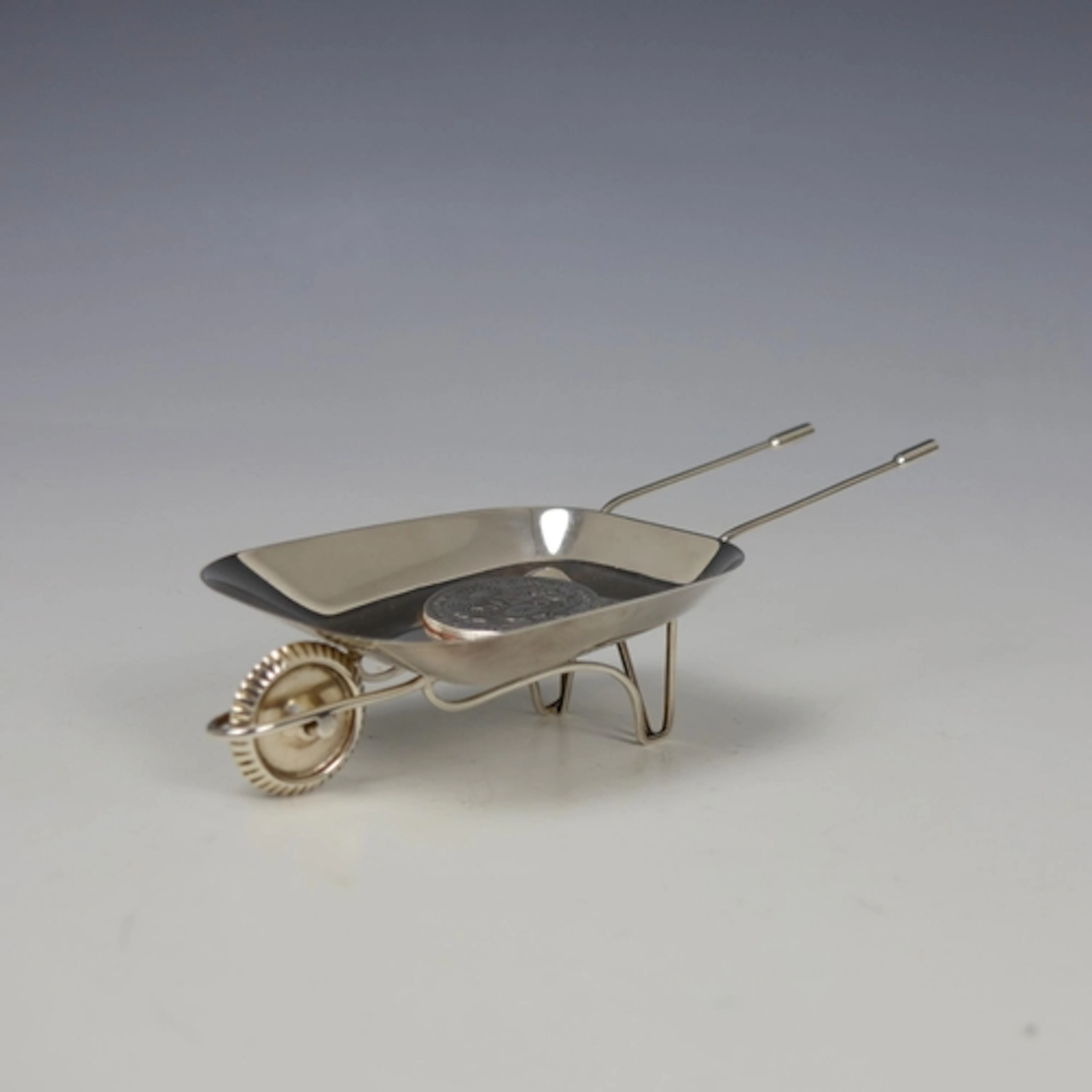 An early 20th century Peruvian white metal novelty wheelbarr...