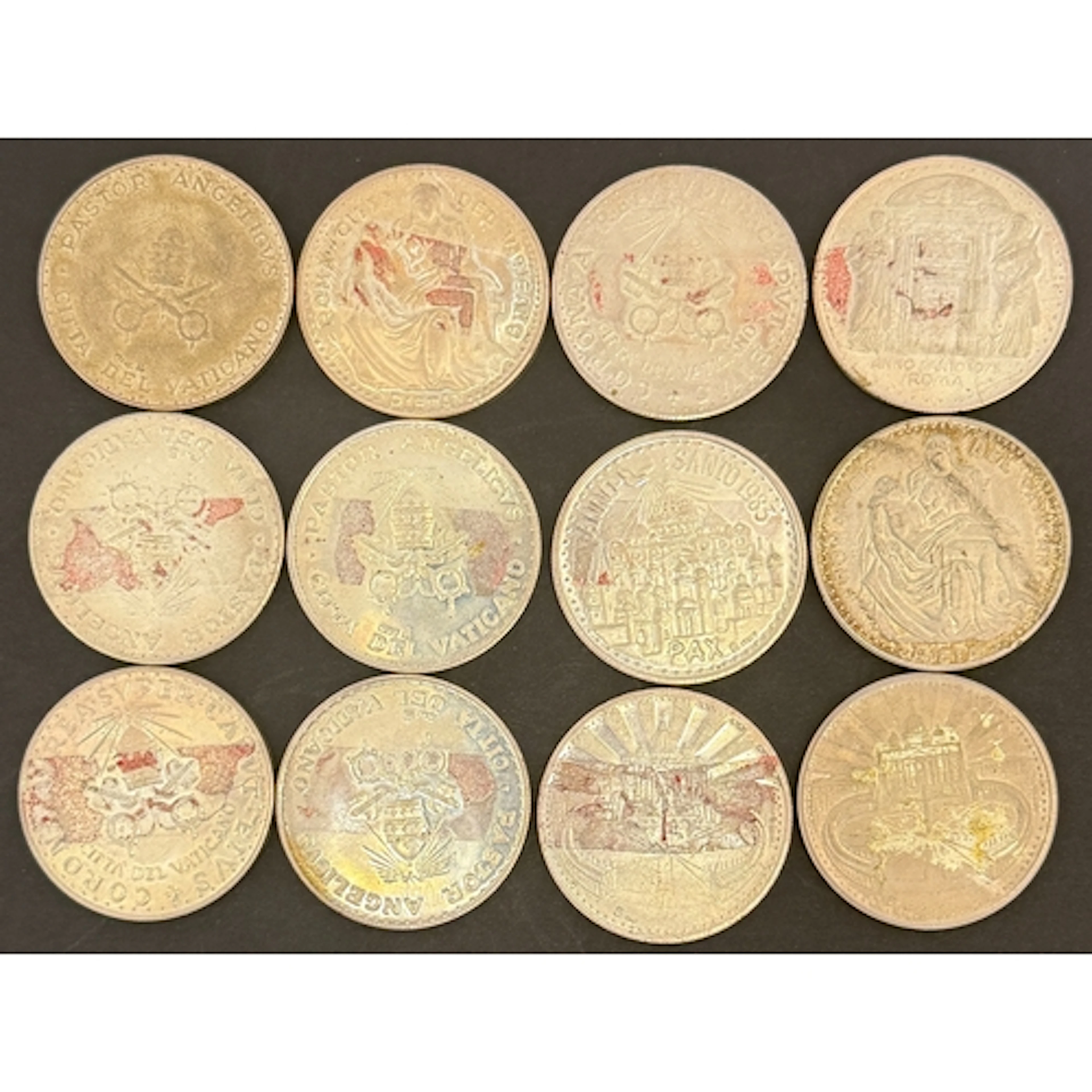 A collection of 12 Vatican commemorative silver medallions, ...