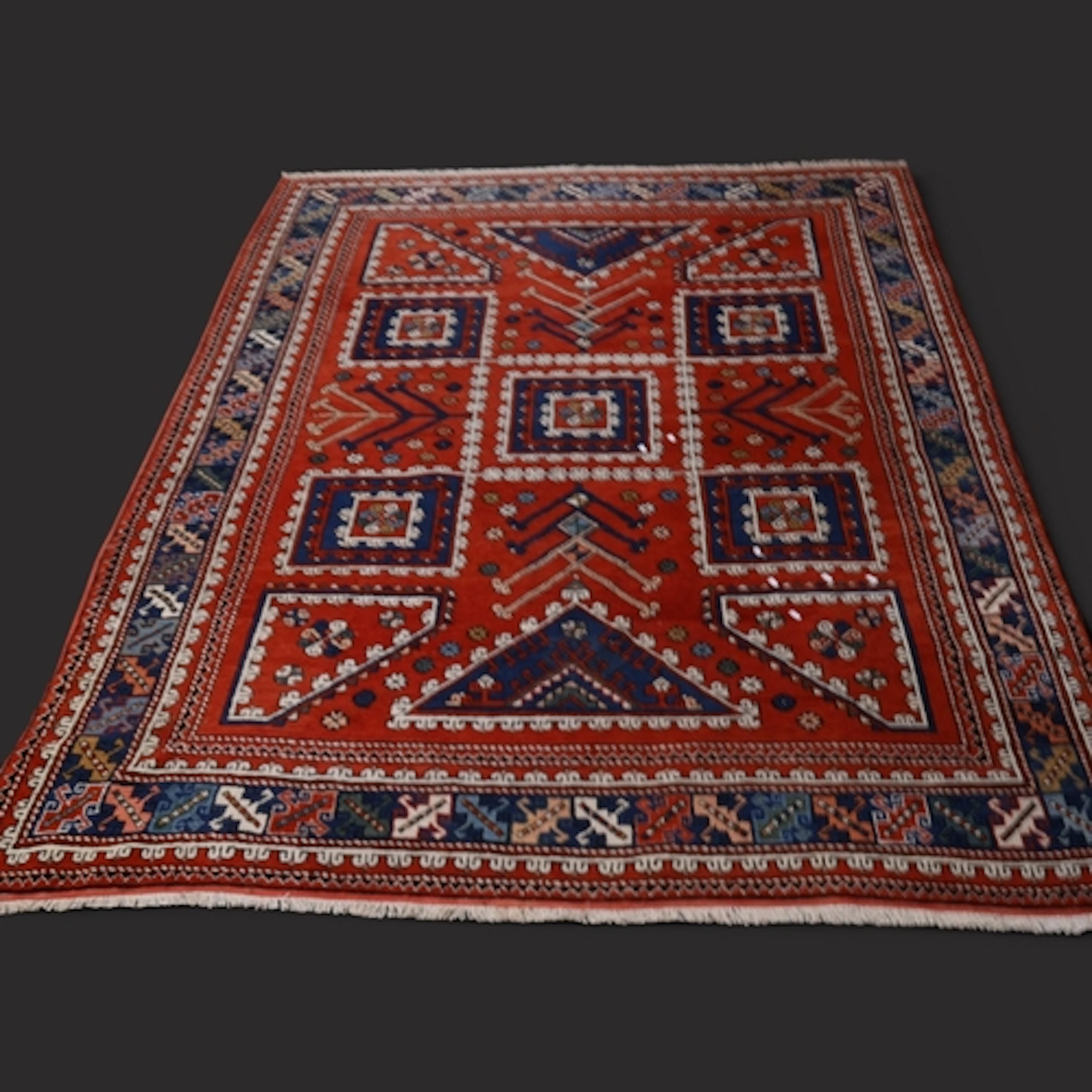 A red and blue-ground Caucasian Kazak carpet. L290cm, W209cm...