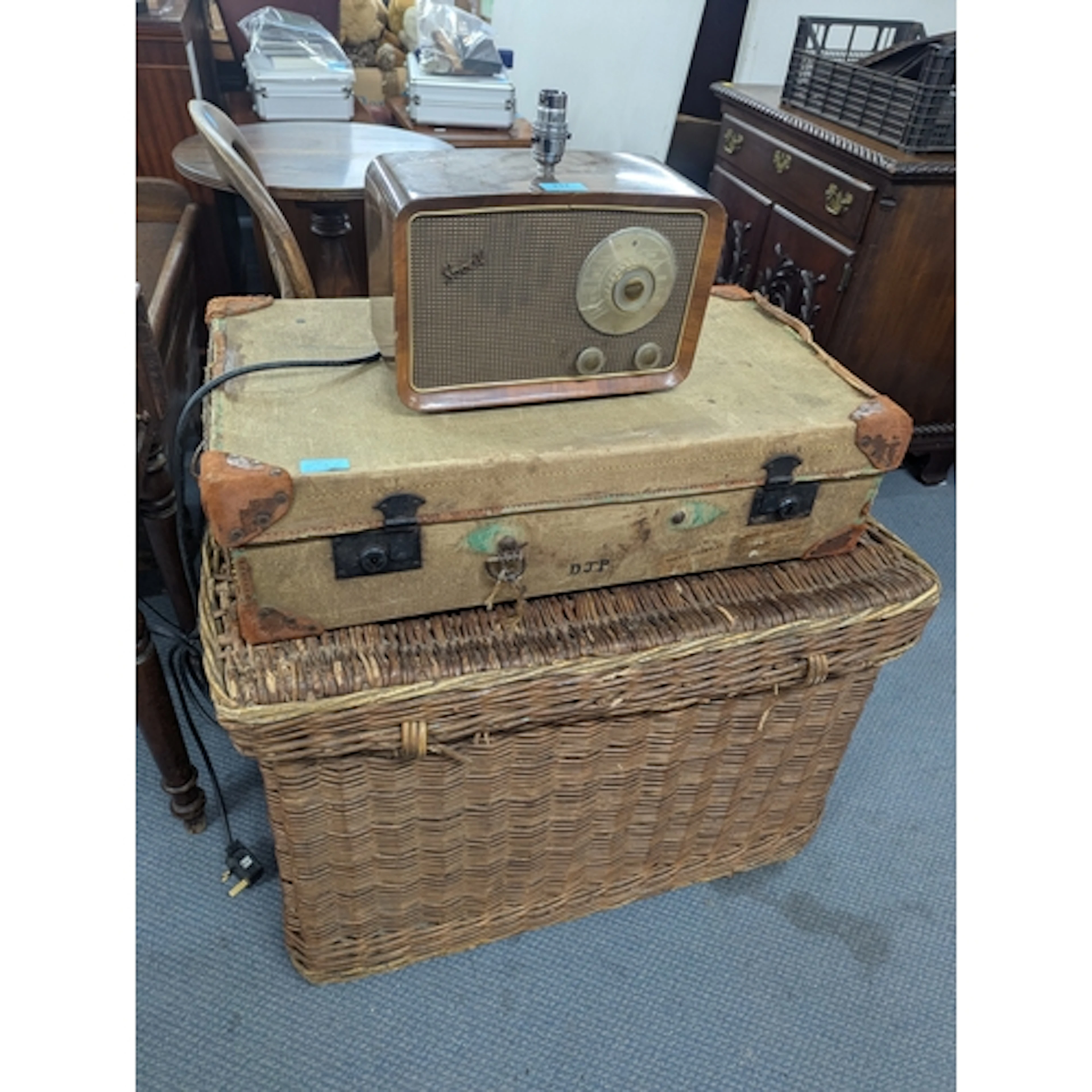 A large wicker basket A/F, a suitcase and a radio converted ...