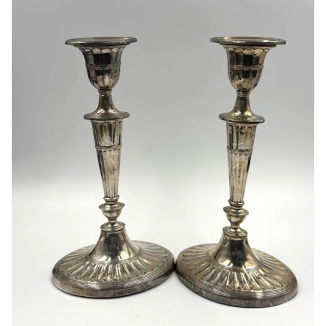 A pair of Adam style and fluted silver candlesticks, with we...