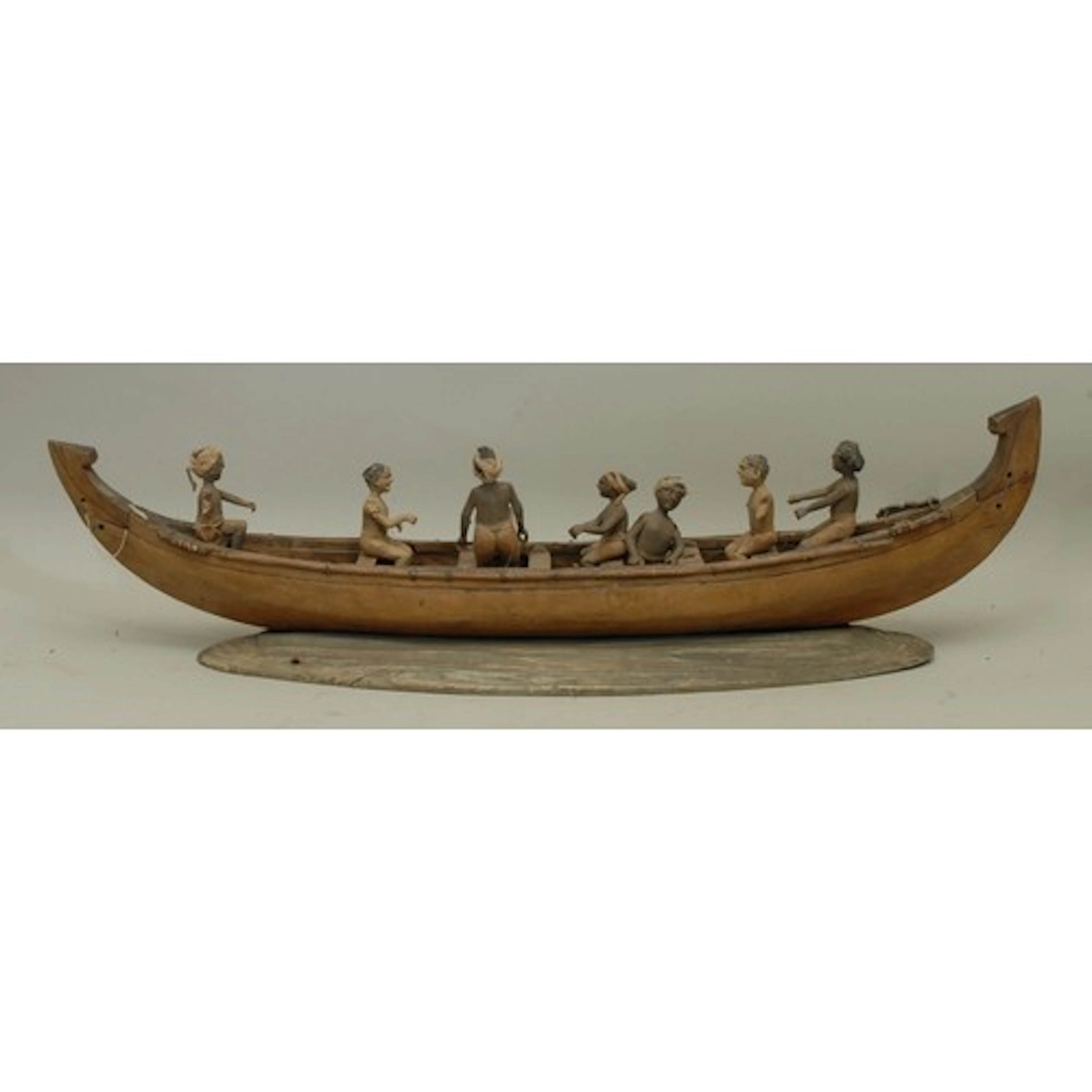 An Indian carved and painted softwood model, of a boat and c...