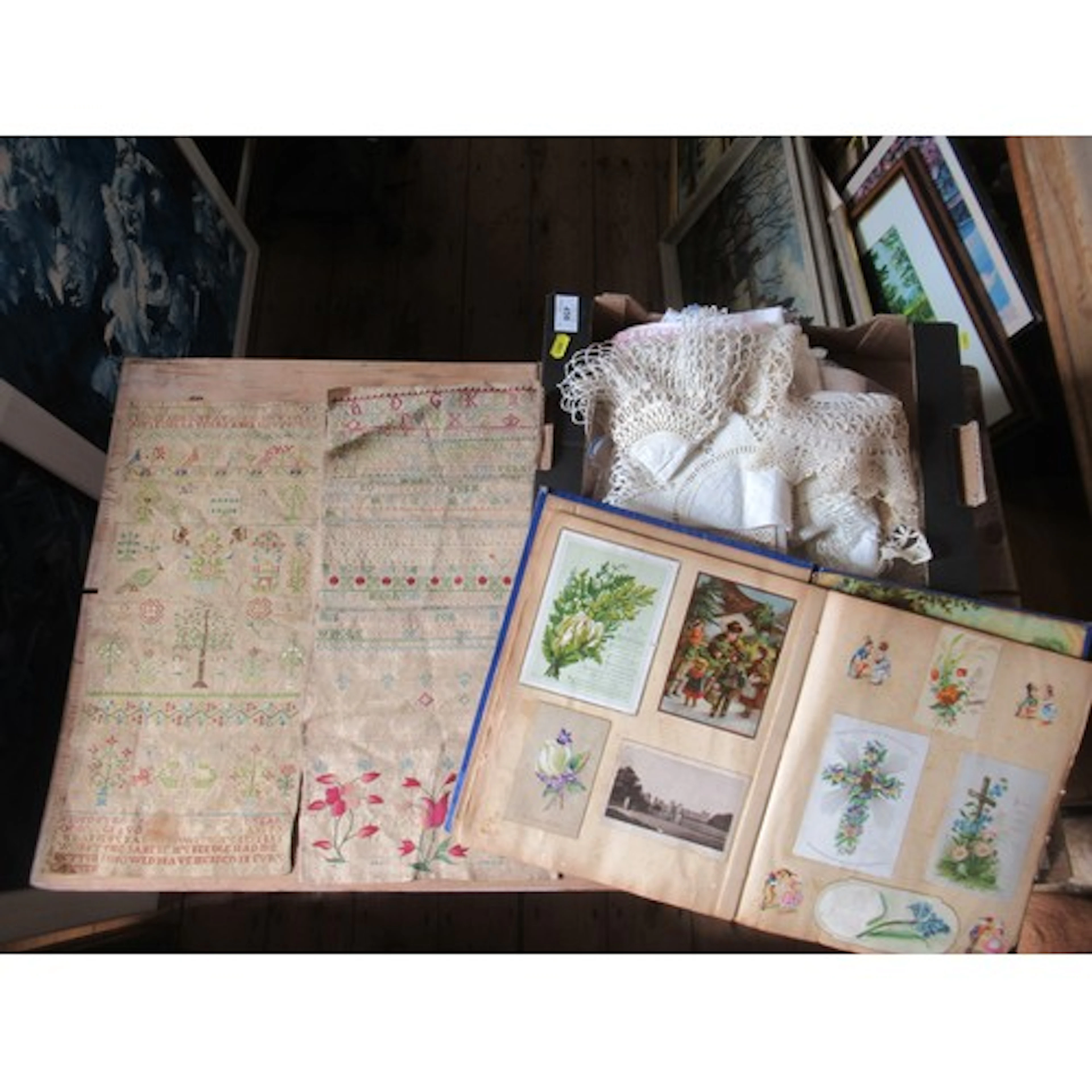 A box of linen, together with unframed Antique samplers and ...