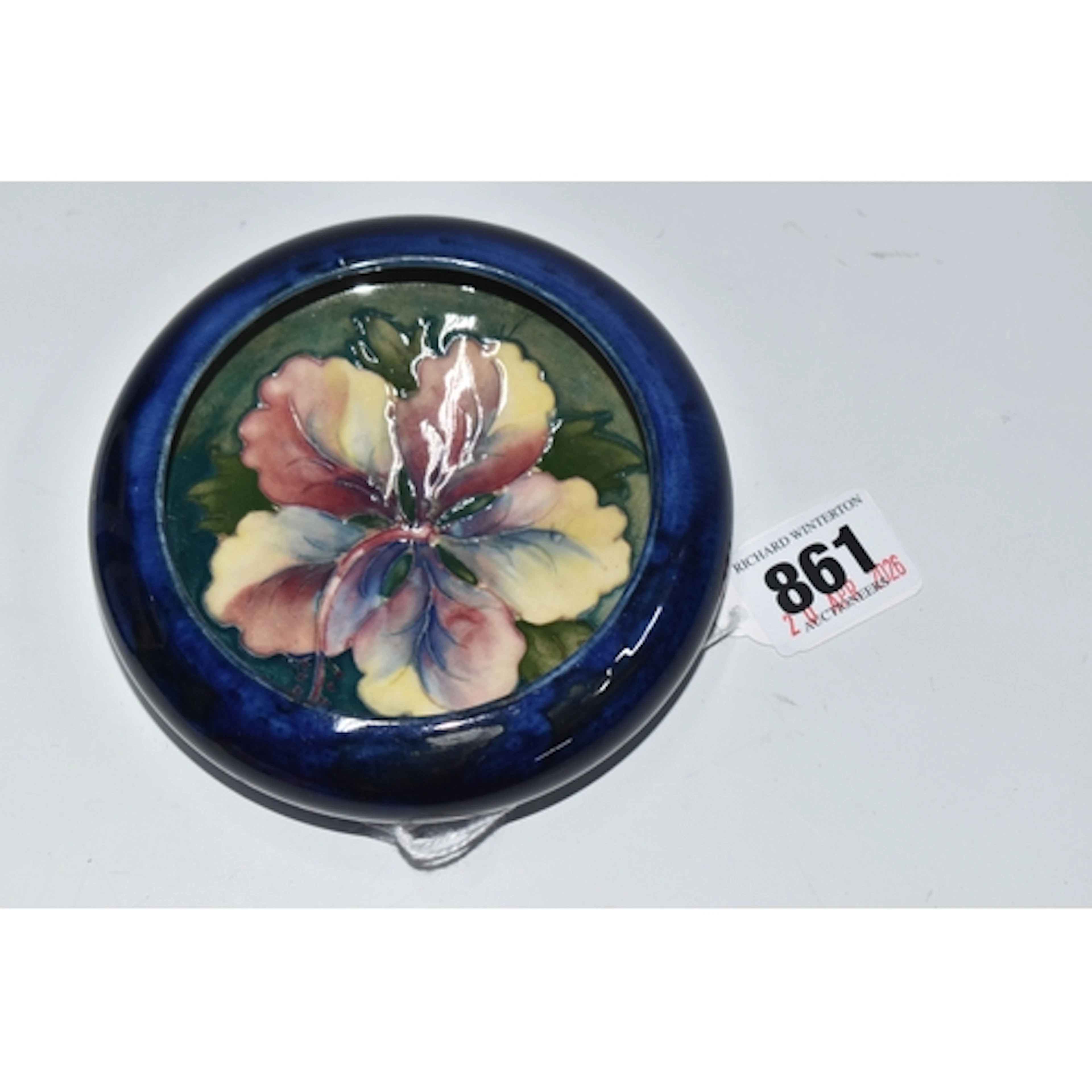 A MOORCROFT POTTERY TRINKET DISH, featuring the hibiscus des...