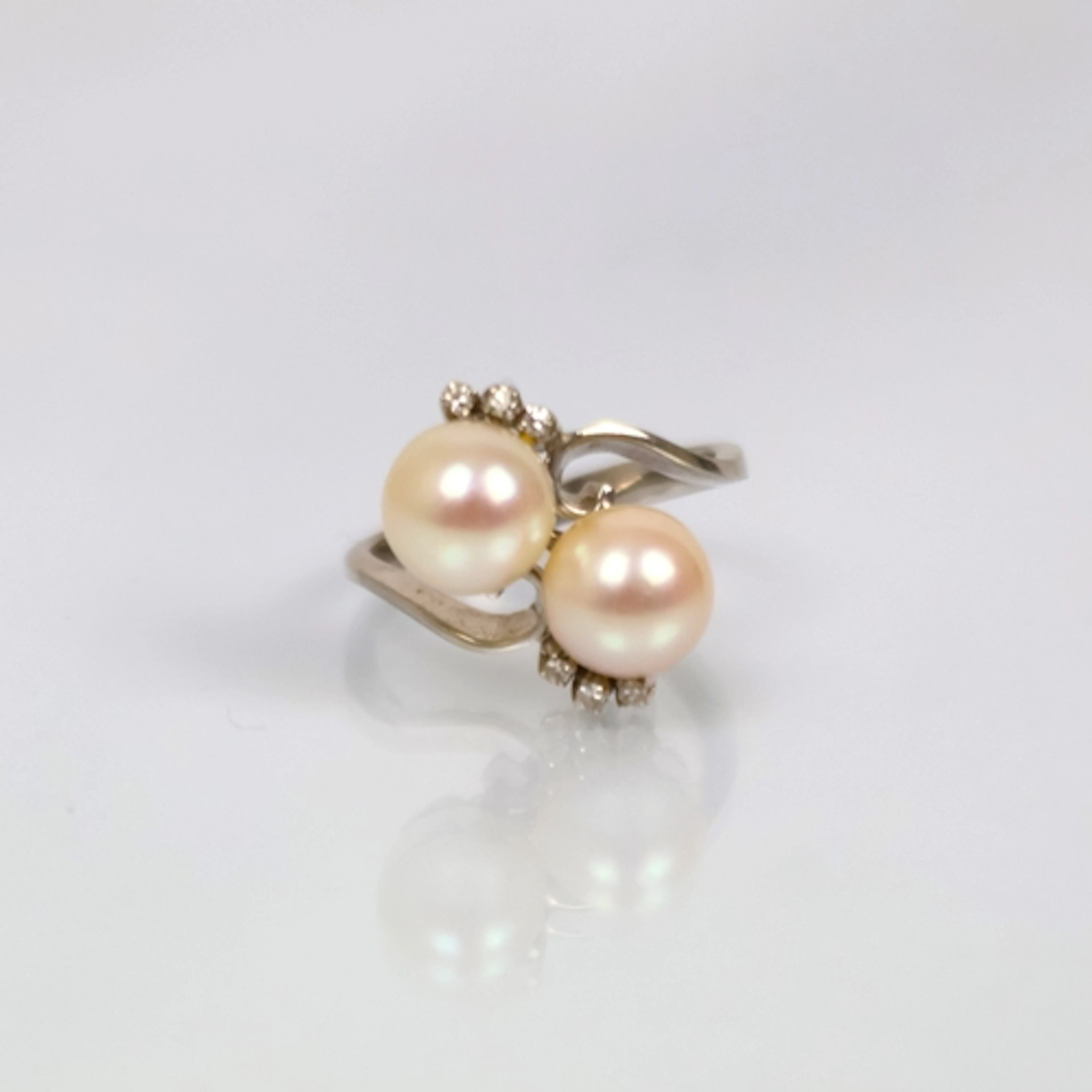 A mid 20th century cultured pearl 'toi et moi' ring, the two...