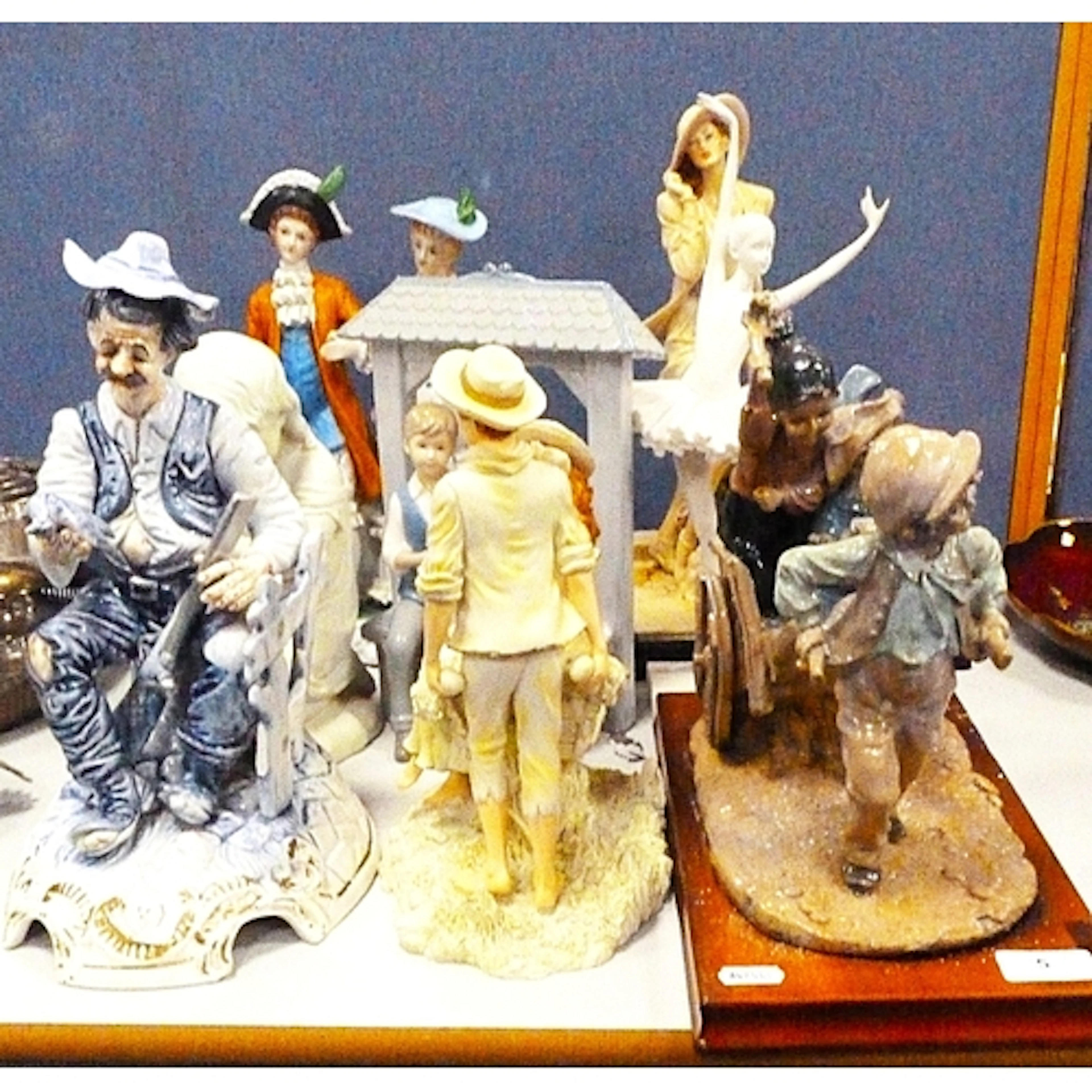 A group of assorted figurines to include a Capodimonte examp...